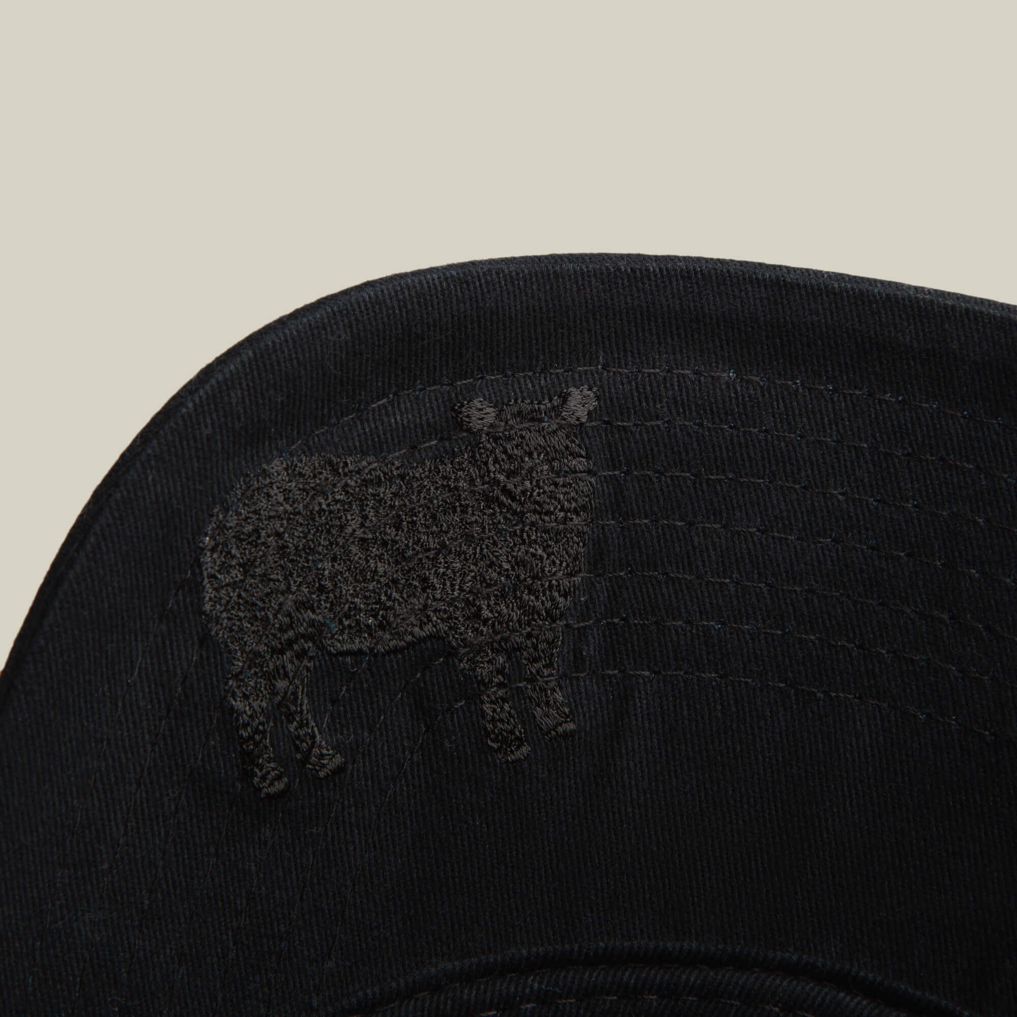 A close-up of the Goorin Bros. "Define Yourself - Black Sheep" low profile cap, showcasing an embroidered sheep outline on the brim against a plain, light background.