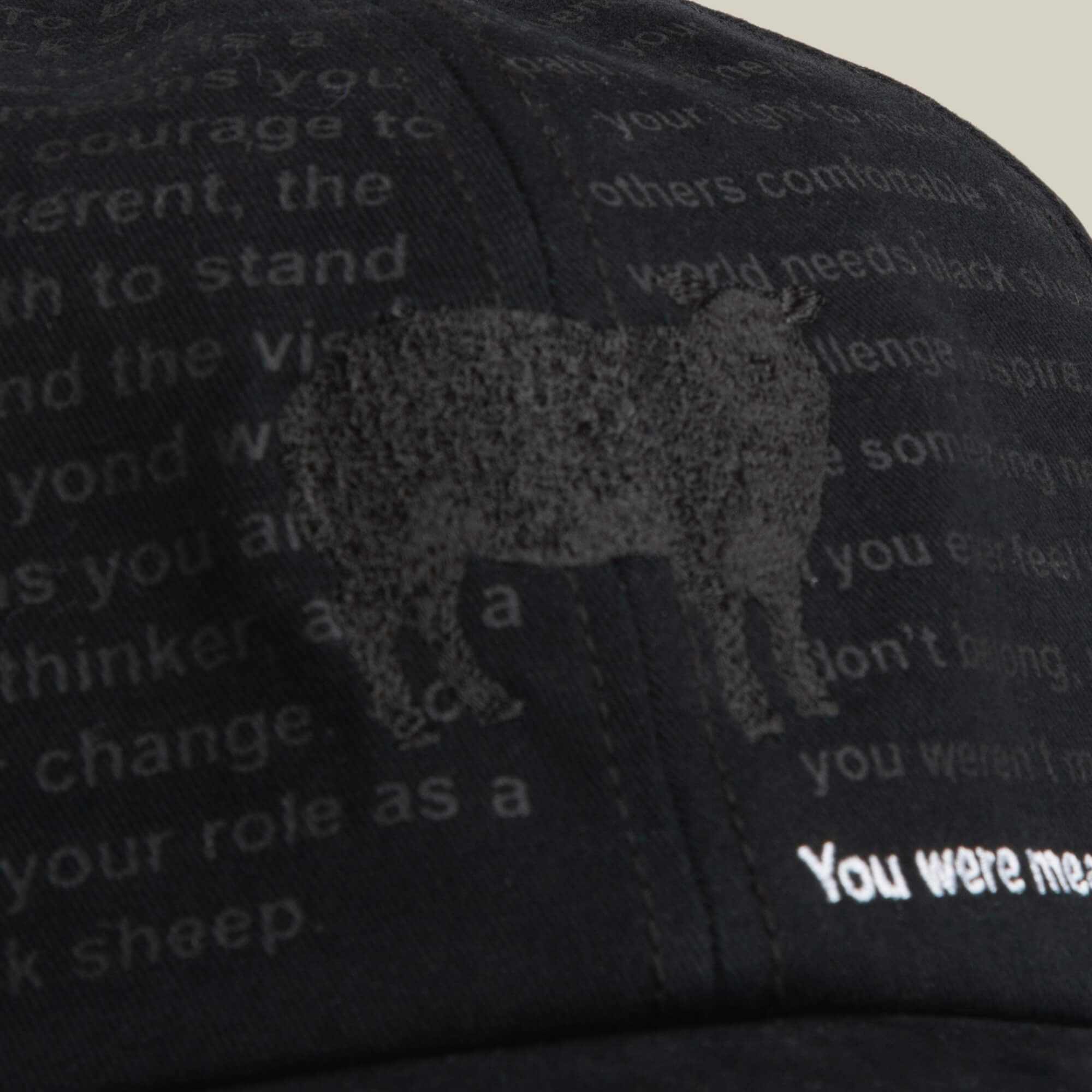 The Define Yourself - Black Sheep cap by Goorin Bros. is a low-profile papa hat featuring a subtle black sheep graphic and partially visible white text across the front.