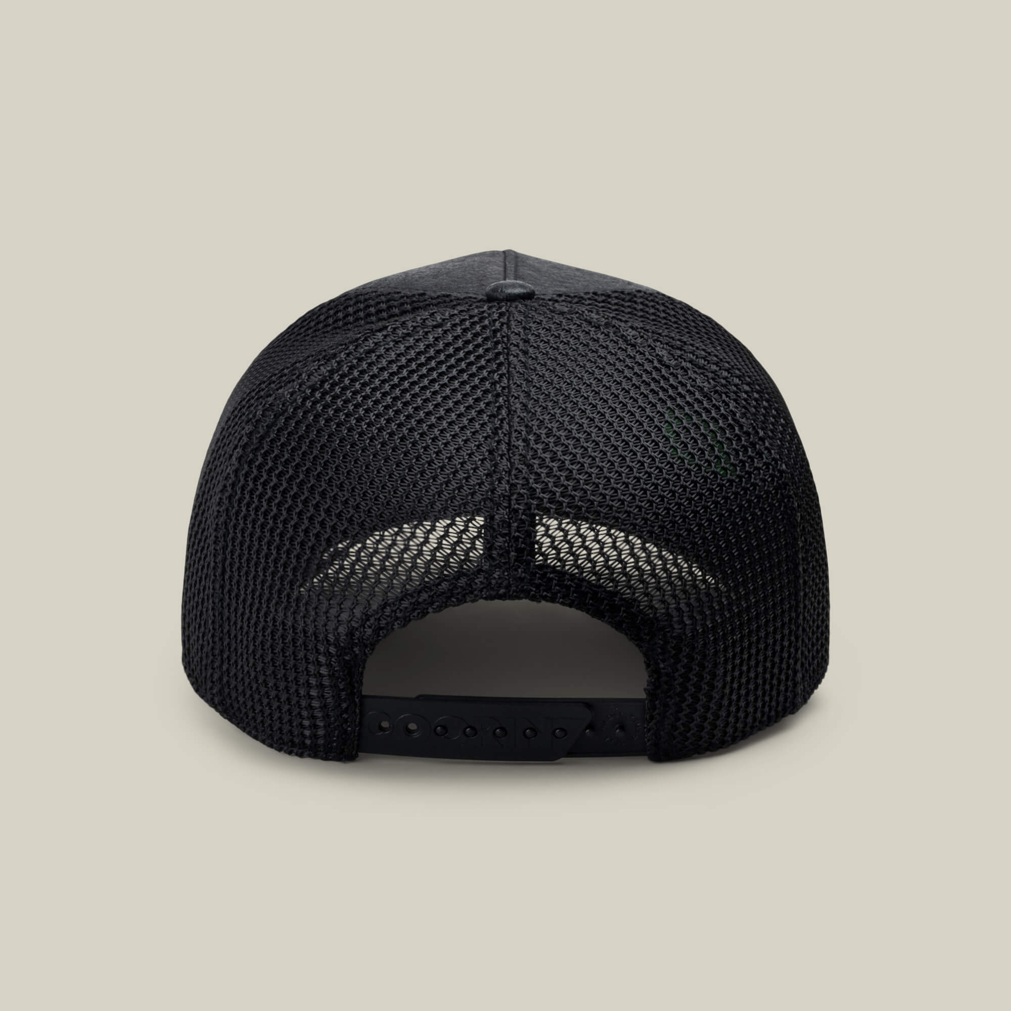 NeoBrand GOAT by Goorin Bros.—black mesh-back trucker hat shown from the rear with adjustable snapback closure and subtle branding, set against a beige background. Ideal to match with your favorite monochrome sneakers.
