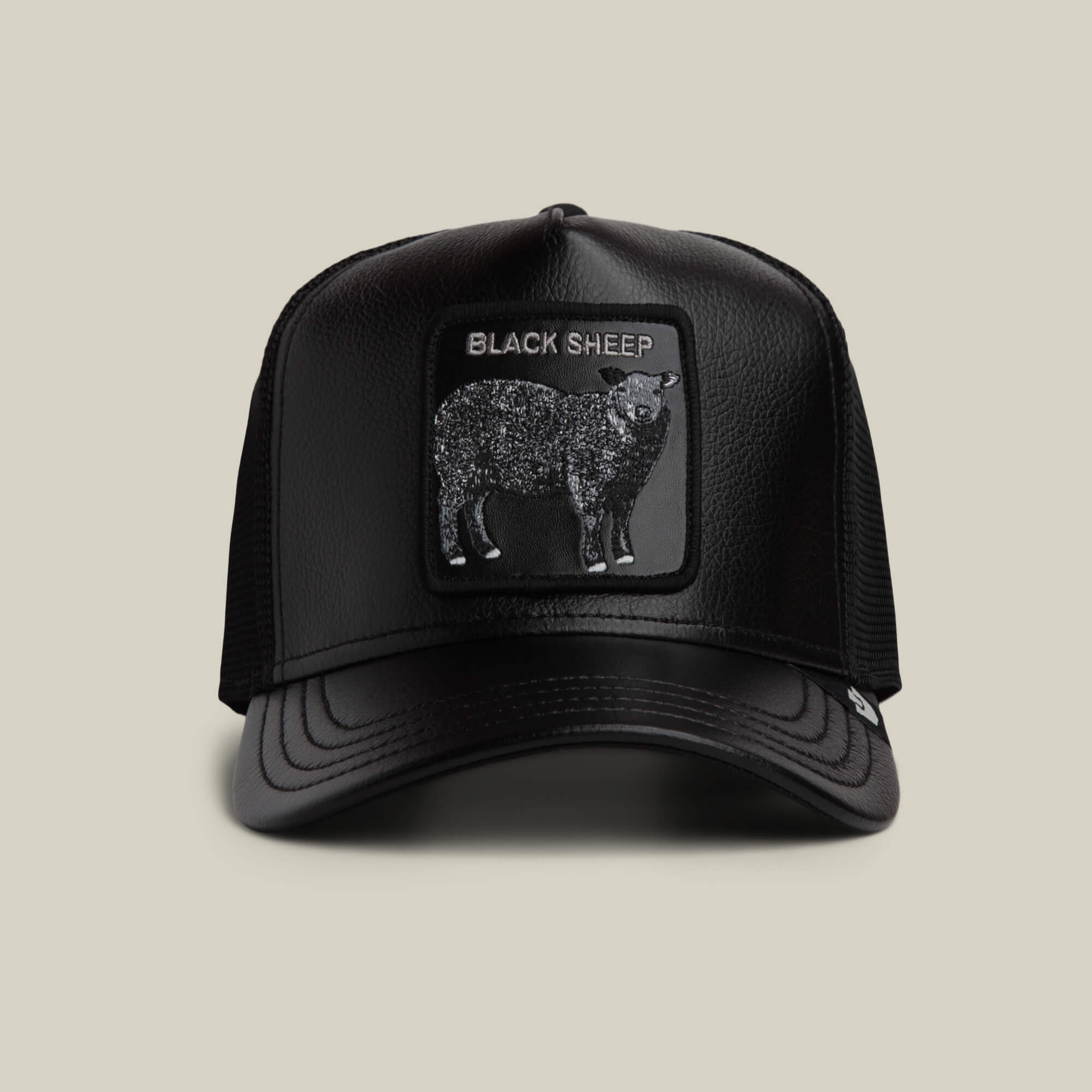 The Goorin Bros. Faux Leather Sheep trucker hat in VOID features a rectangular black sheep patch with "BLACK SHEEP" on the front and a faux leather brim, shown against a plain background.