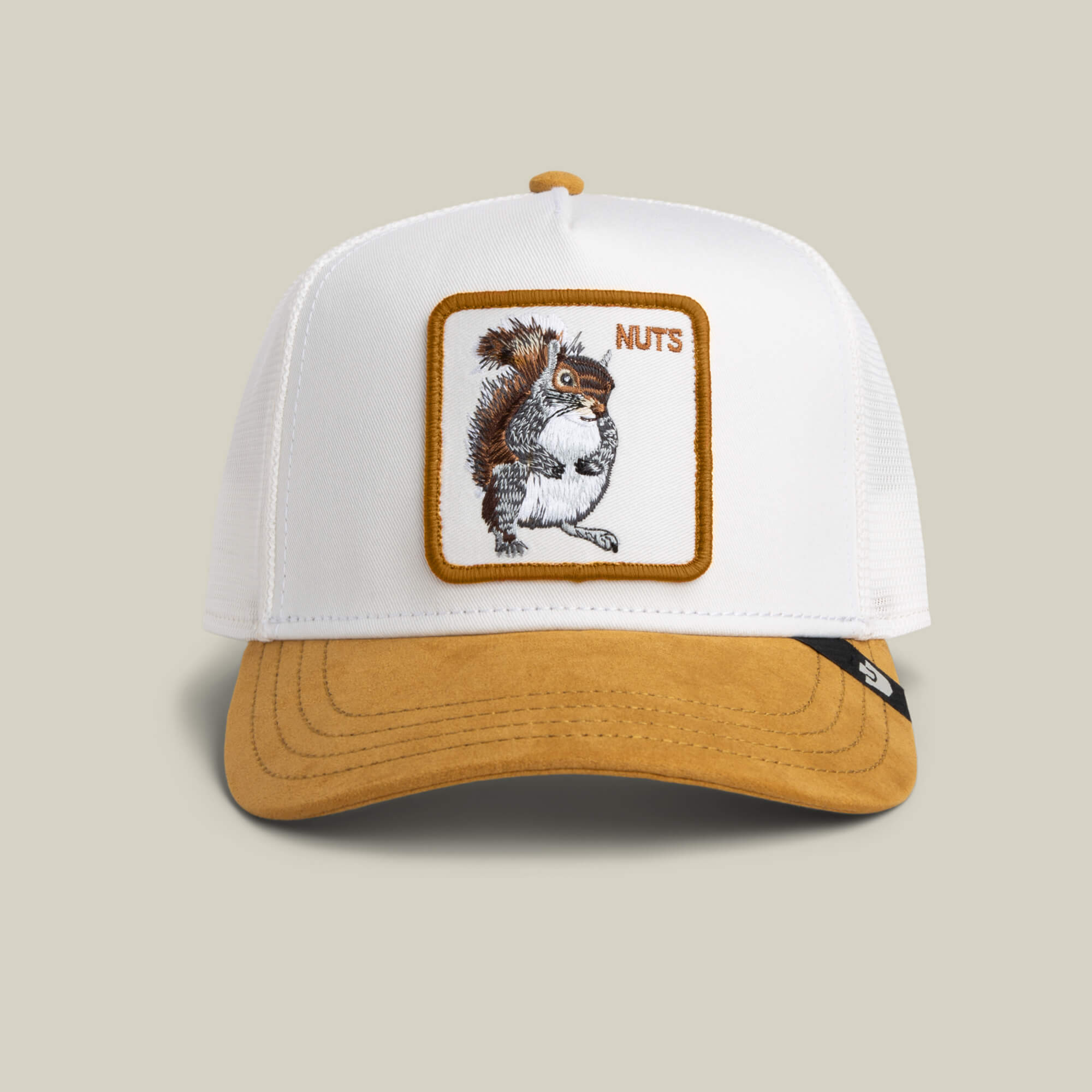 The Goorin Bros. Suede Squirrel cap in DUST/AMBER features a cute squirrel patch with a nut and the word "NUTS" in the corner.