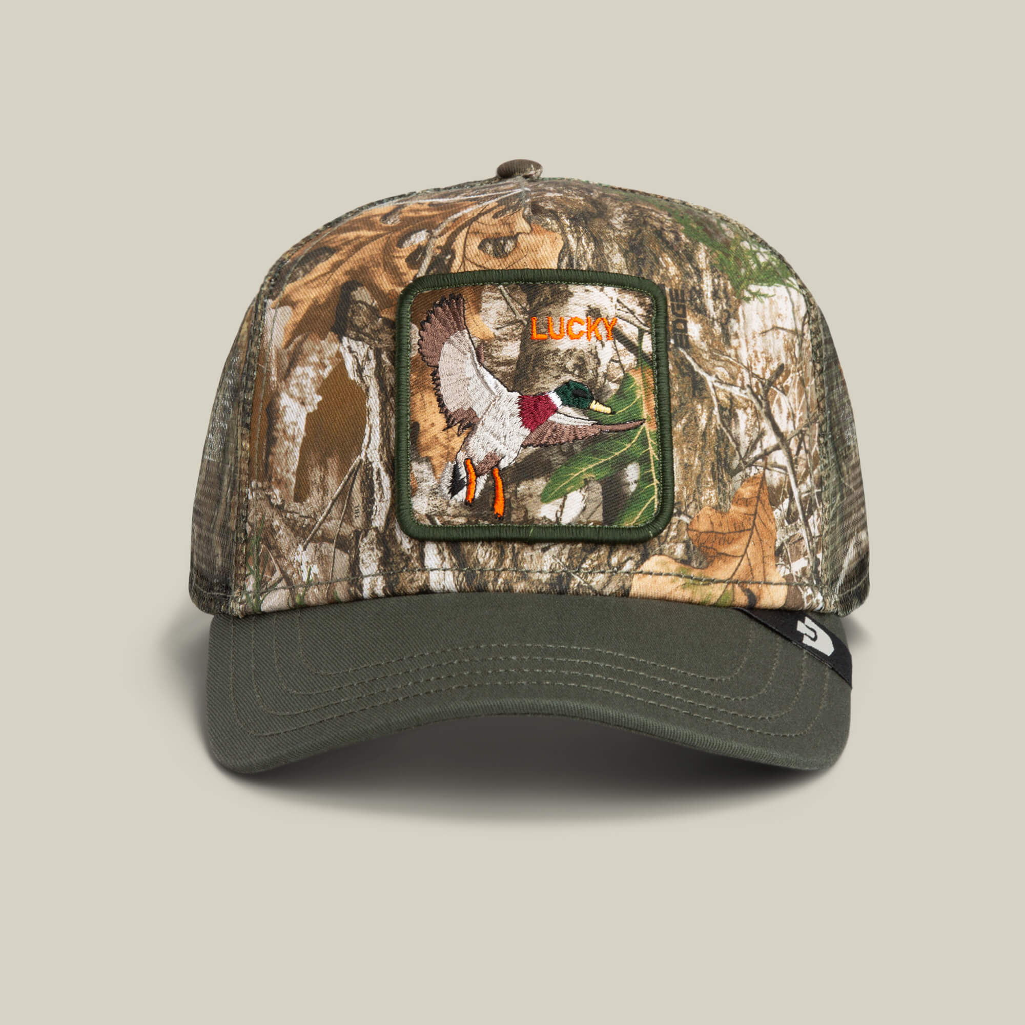 The Goorin Bros. Realtree Edge Lucky Duck cap features a camouflage design with a green bill, a duck patch, and "LUCKY" embroidered above a flying duck.
