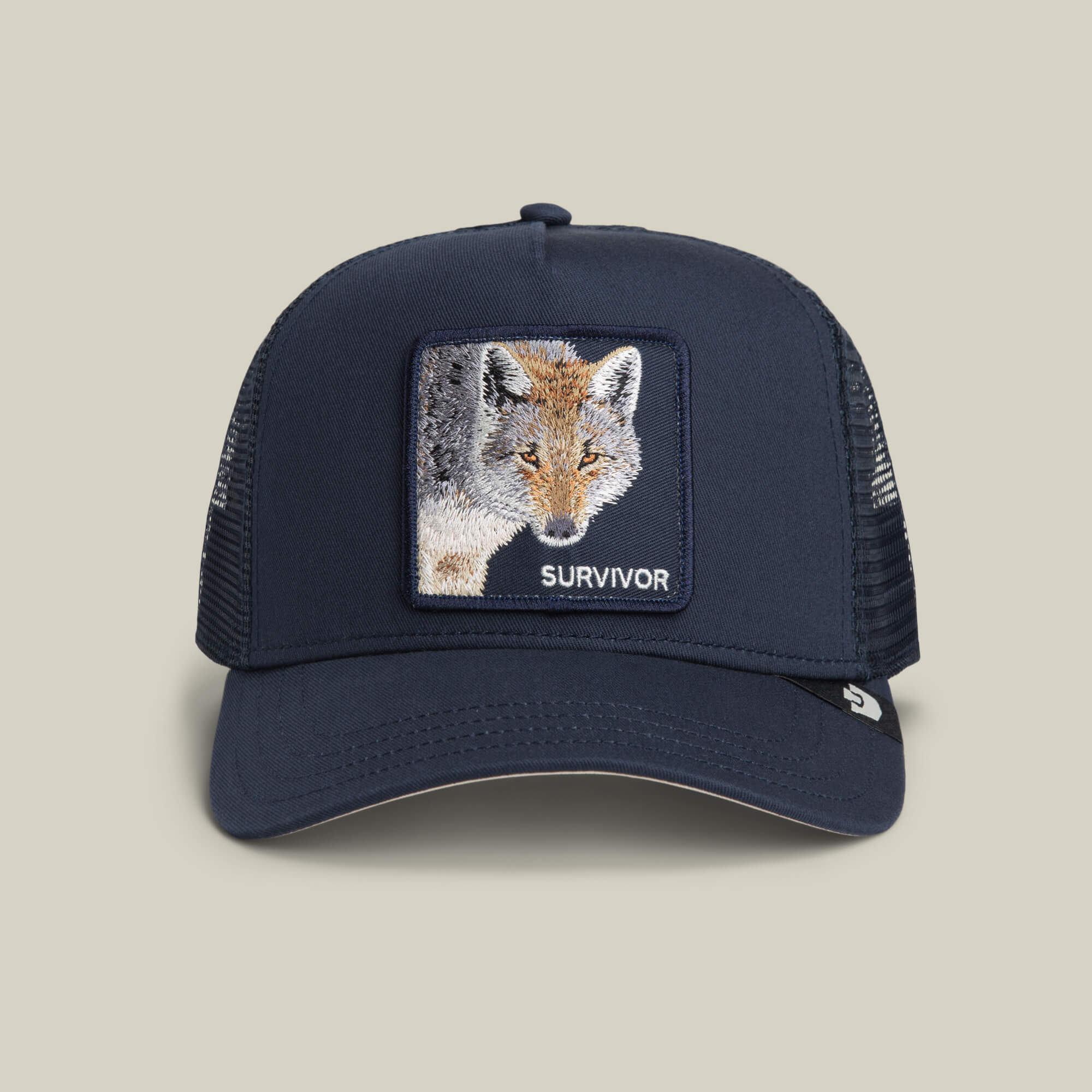 The Mirage Survivor by Goorin Bros. is a trucker hat in EDGE color, featuring a mesh back and a rectangular patch with an embroidered fox and "SURVIVOR" on the front—perfect for standout survivor style.