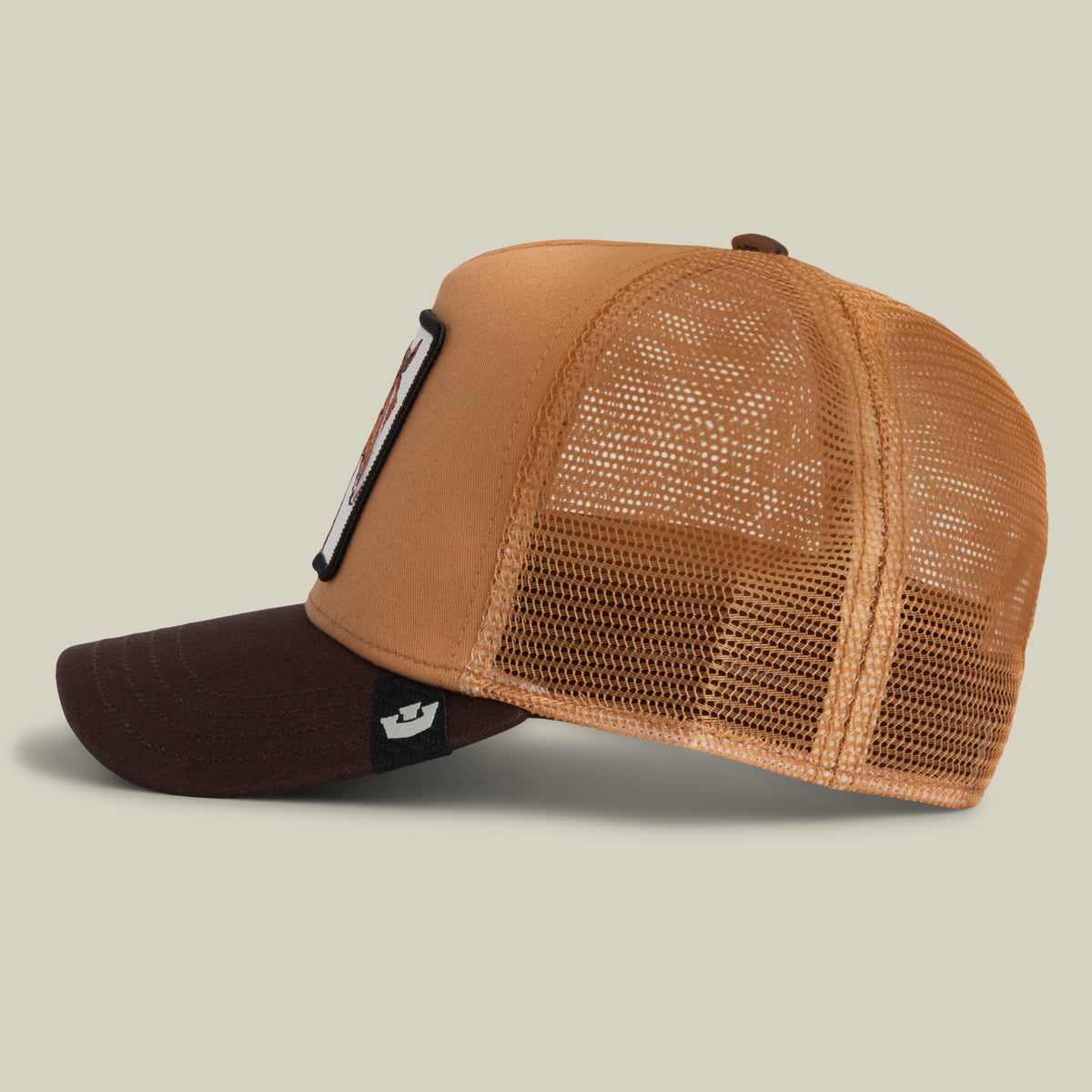 Side view of a tan and dark brown Gaucho Trucker hat in an earthy colorway, featuring a horse patch on the front panel and a mesh back.
