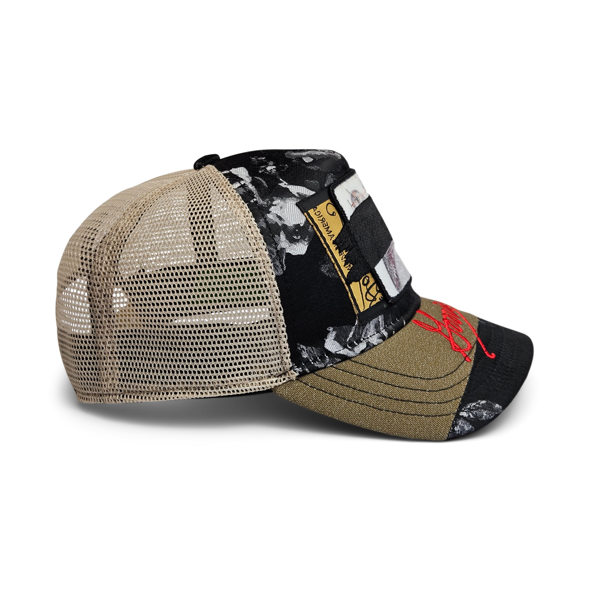 Side view of the Goorin Rework Trucker by Goorin Bros., a limited edition trucker hat with a mesh back, black and olive green floral-patterned fabric, decorative patches, and red embroidery on the brim.