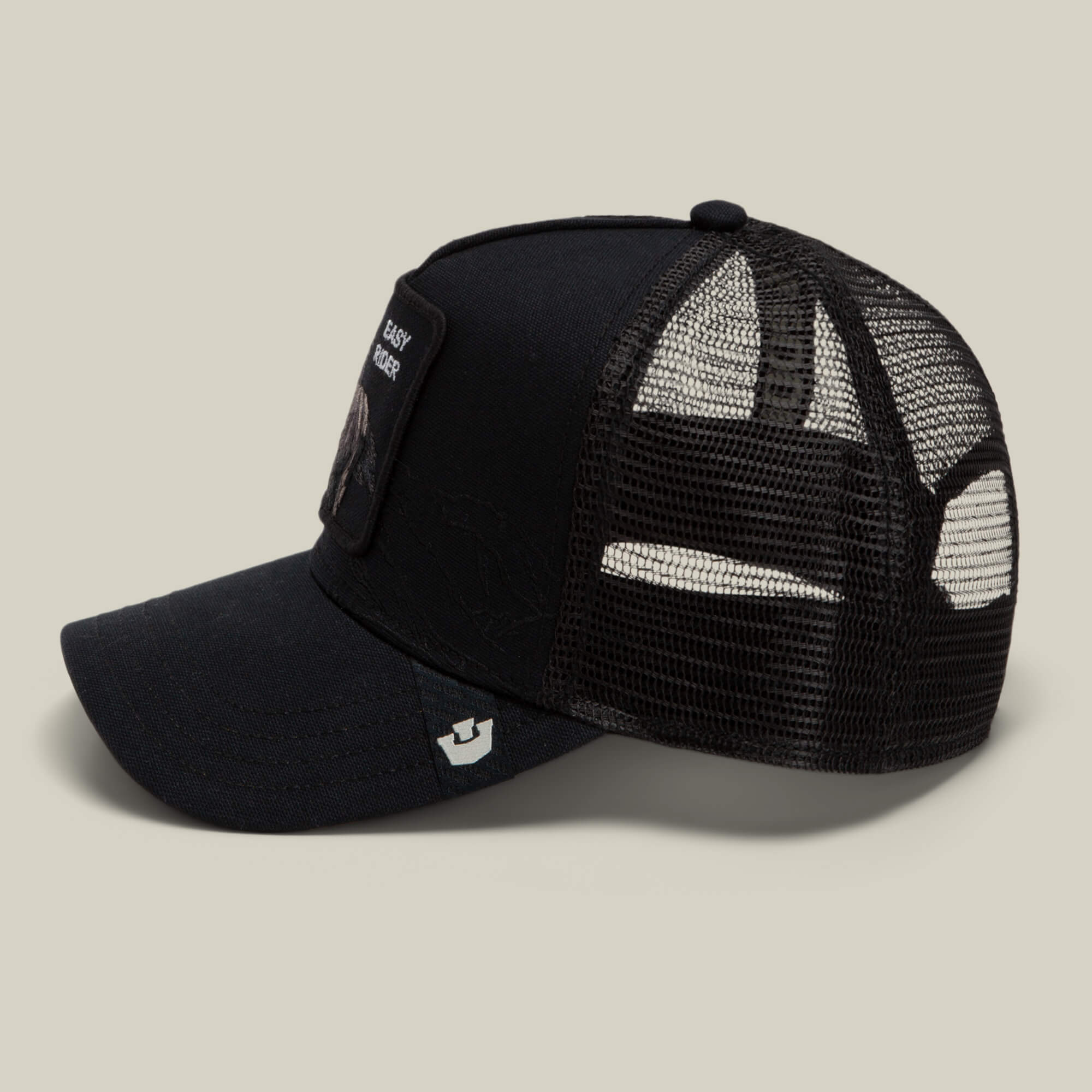 Badlands Stallion by Goorin Bros.: a black trucker hat featuring mesh back panels, a front patch, and a small logo on the brim, displayed against a neutral background.