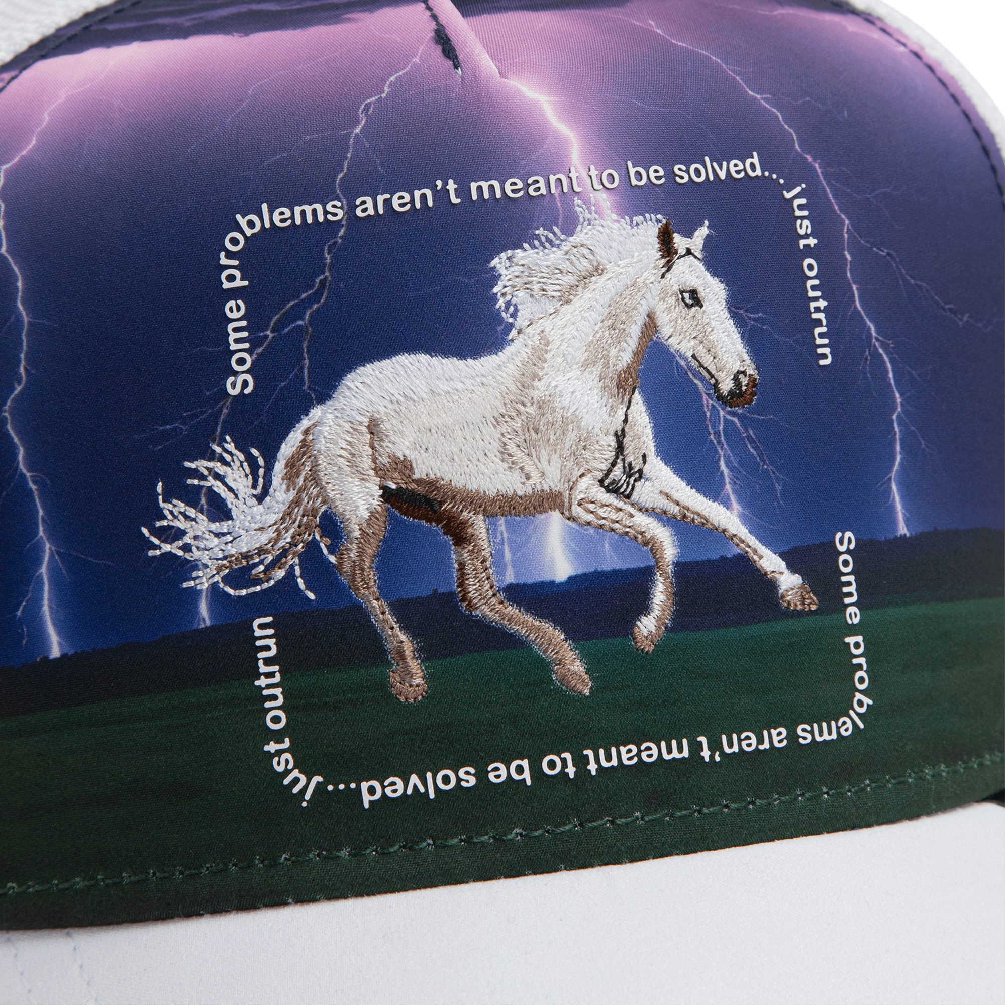 The Goorin Bros. "Through the Storm - Horse" trucker hat features a white horse embroidered against a stormy, lightning-filled sky with text: "Some problems aren’t meant to be solved… just outrun.