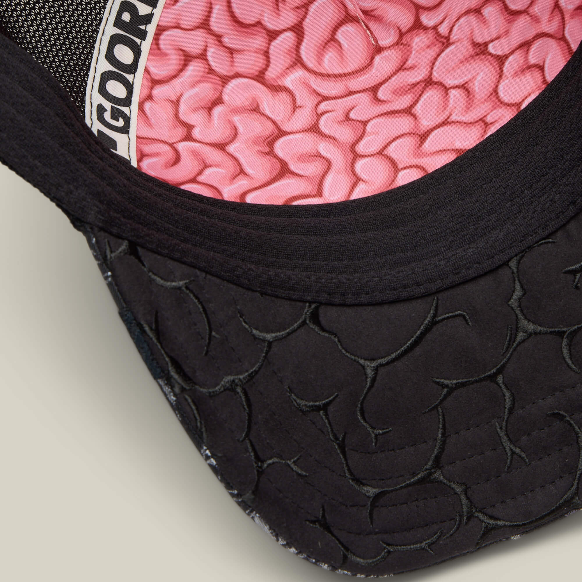 Close-up of the Goorin Bros. "Gray Matter" hat—black with a textured brim and a pink gray matter pattern on the inner lining. A bold new Friday drop for standout style.