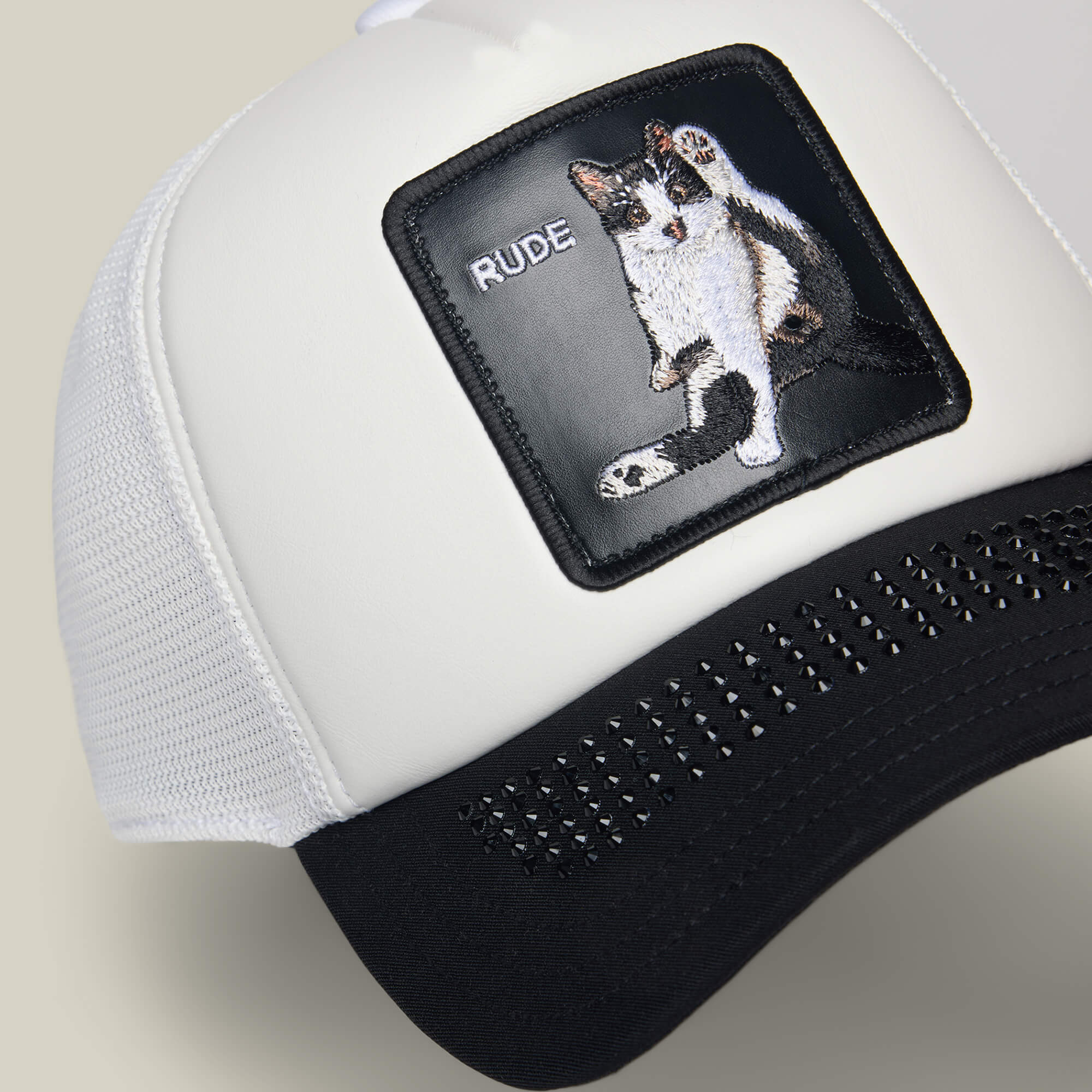 The Goorin Bros. "R U Done Eating?" trucker hat features white and black panels with a front patch of an embroidered cat and the word RUDE—a bold accessory to elevate your look.