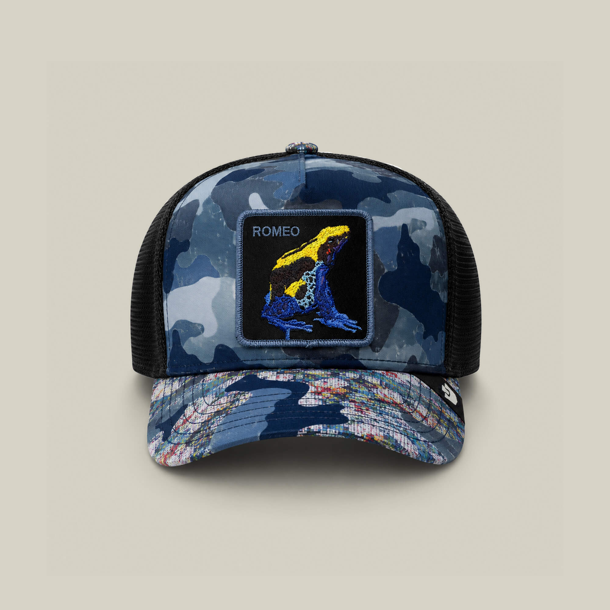 The Goorin Bros. Warfare Art Thou trucker hat in EDGE features a vibrant Romeo poison dart frog patch and ROMEO on the front—an ideal addition to any Blue Battalion cap collection.