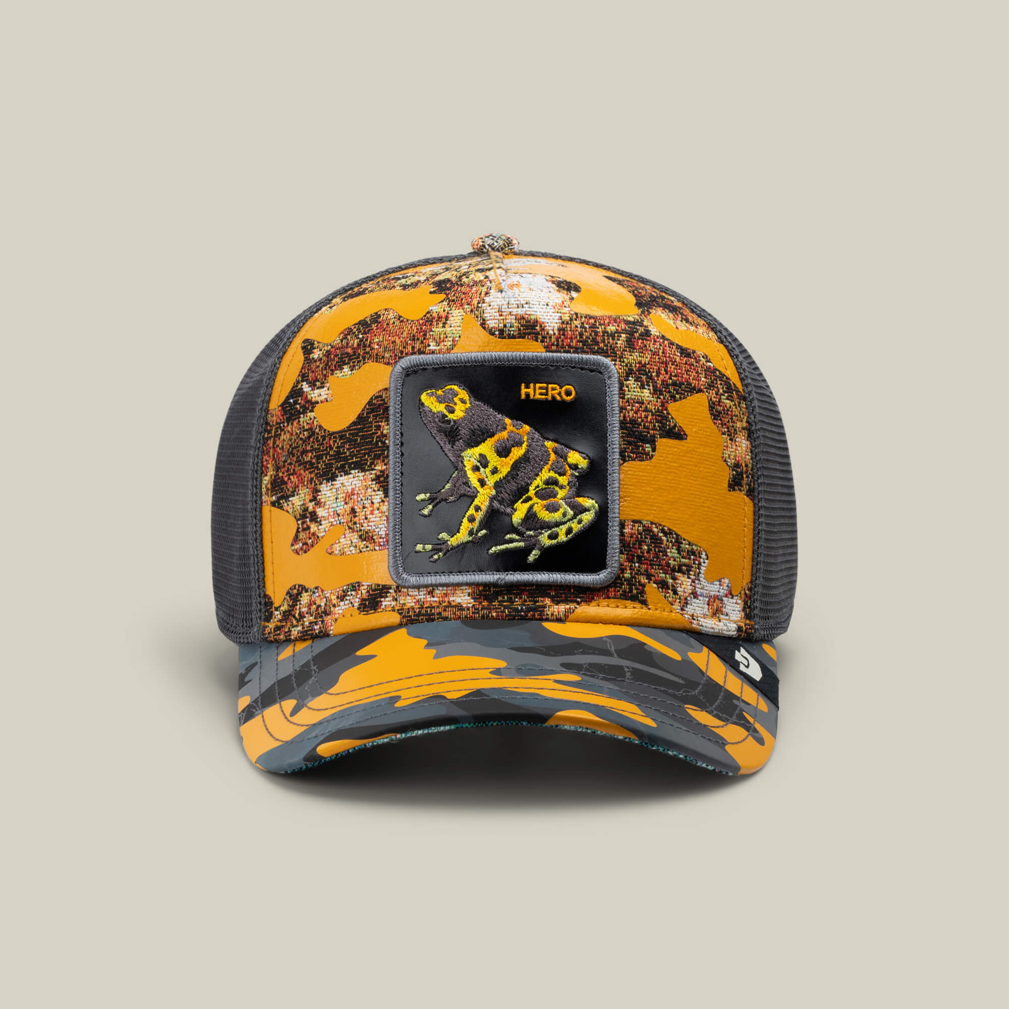 A LUCKY camo trucker hat by Goorin Bros., called Knight in Sliming Armor, features a mesh back and a Hero patch with a yellow and black frog—ideal for any Yellow Swamp Battalion fan.
