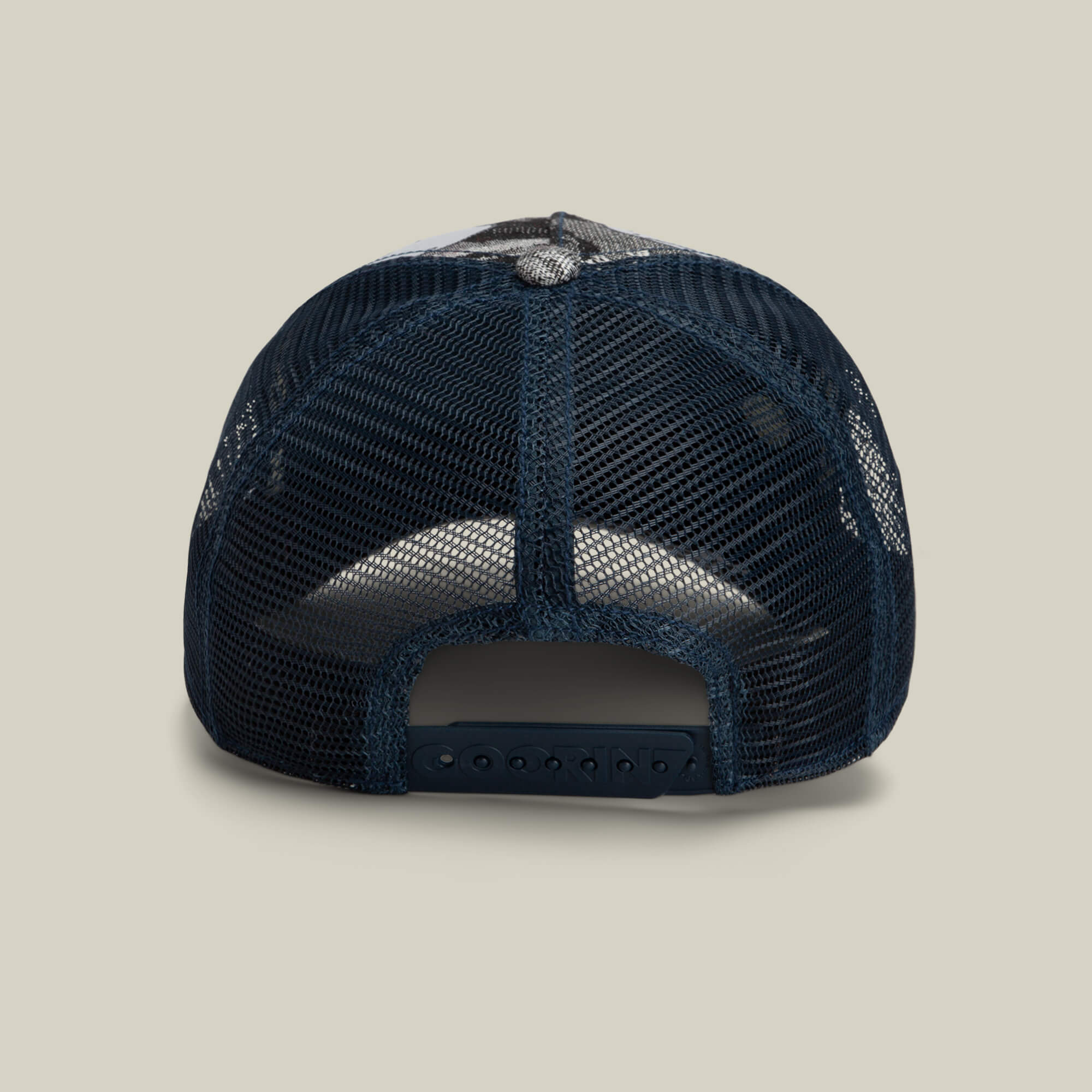 Rear view of the Goorin Bros. Bone Head Danger hat in navy blue, featuring a mesh back and adjustable plastic snap closure, displayed on a plain light beige background.