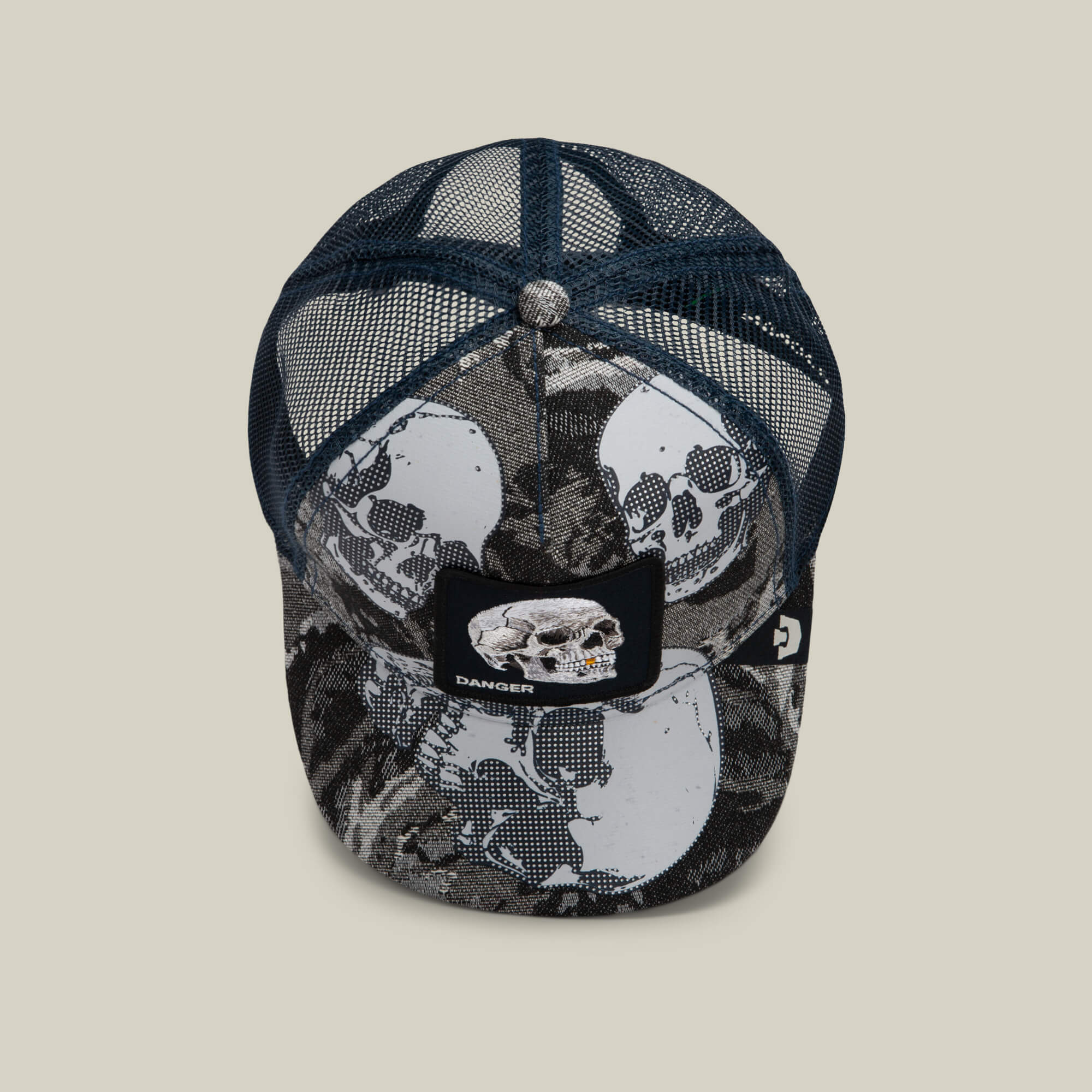Goorin Bros. “Bone Head Danger” hat: a blue mesh-back cap featuring bold skull graphics and a front patch embroidered with a skull and the word “DANGER,” shown against a plain background.