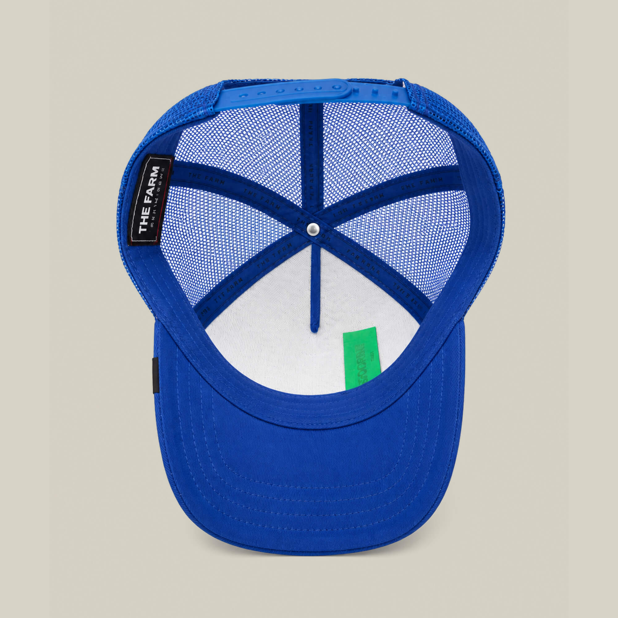 The Empire State of Mind by Goorin Bros. is a blue trucker hat with mesh panels, an inner label reading THE FARM, and a green tag on the brim. Perfect for fans of NYC style. Now available for pre-order!.
