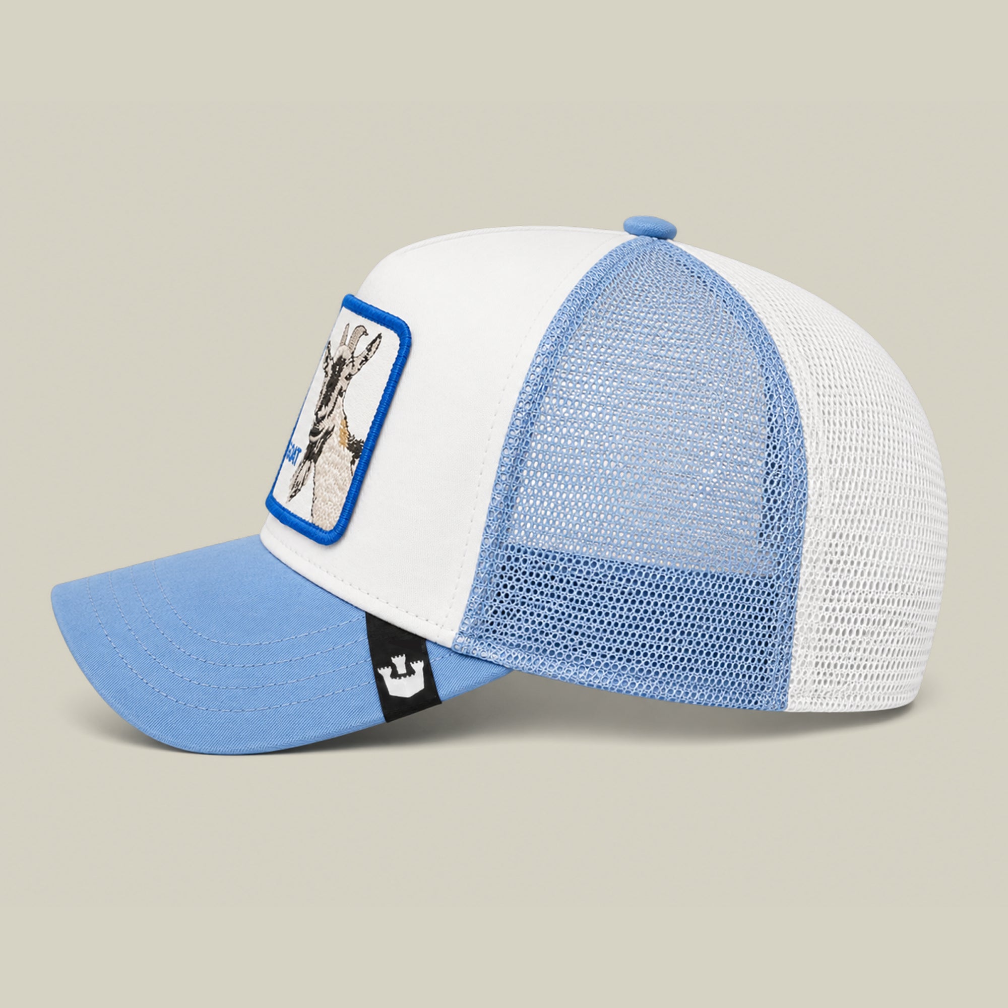The Goorin Bros. La Pulga Atomica is a white and light blue mesh trucker hat with a blue brim and a front patch depicting a giraffe.