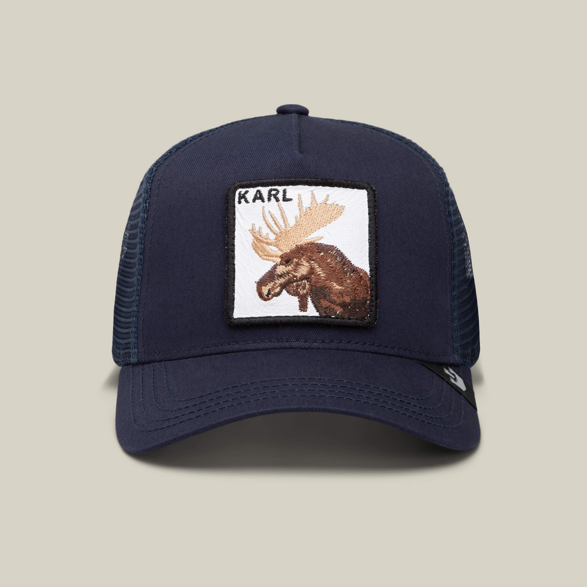 The Goorin Bros. Karlsson Moose is a navy trucker hat with a mesh back, featuring a front patch of a moose and "KARL" above it—a hockey-inspired cap for true fans.
