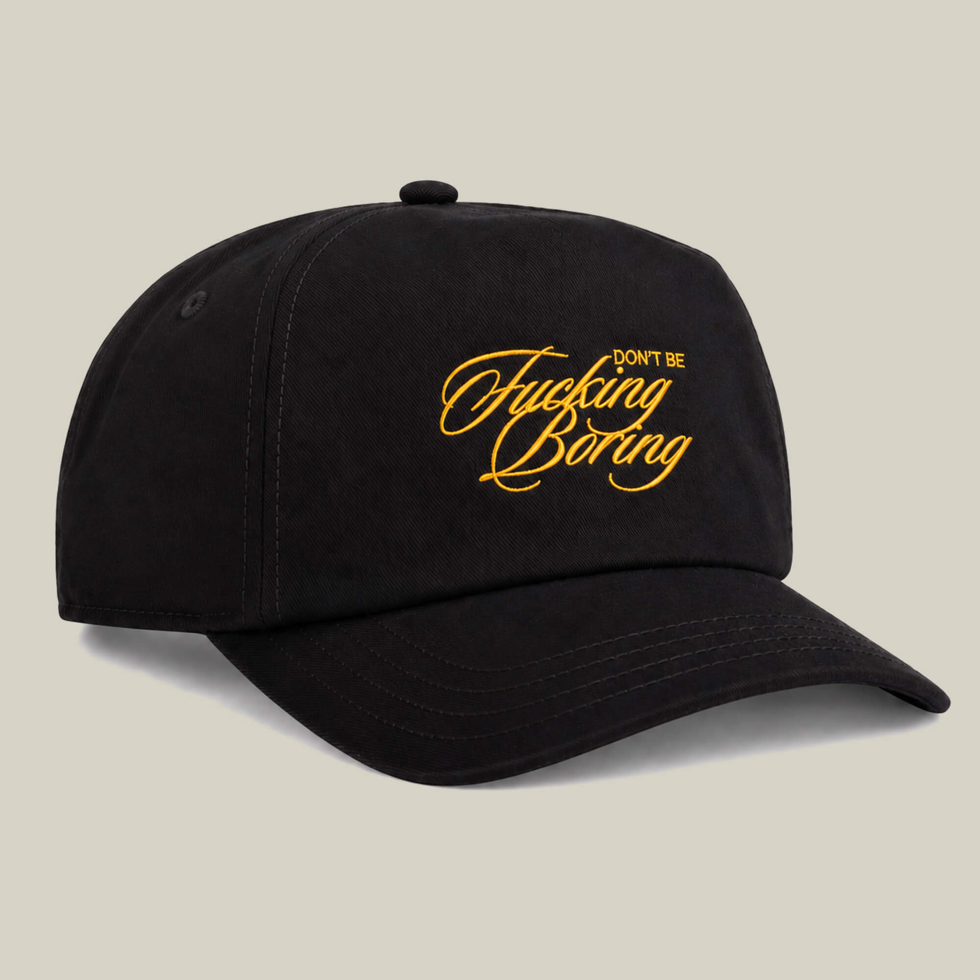 Black two-tone cap by Goorin Bros. featuring yellow “Don't Be Fucking Boring” cursive text on the front, displayed against a plain light background.