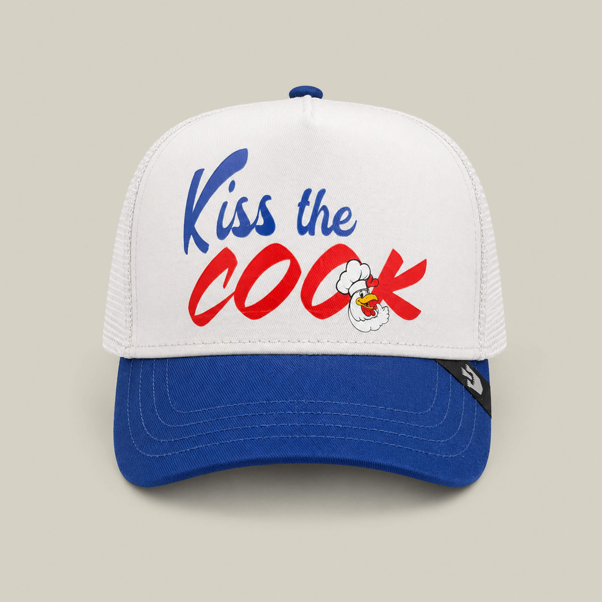 The Chef’s Kiss hat by Goorin Bros. comes in dust and royal colors, featuring “KISS THE COOK” in bold blue and red with a cartoon chicken—ideal for any grillmaster ready to serve up some red hot weiners.