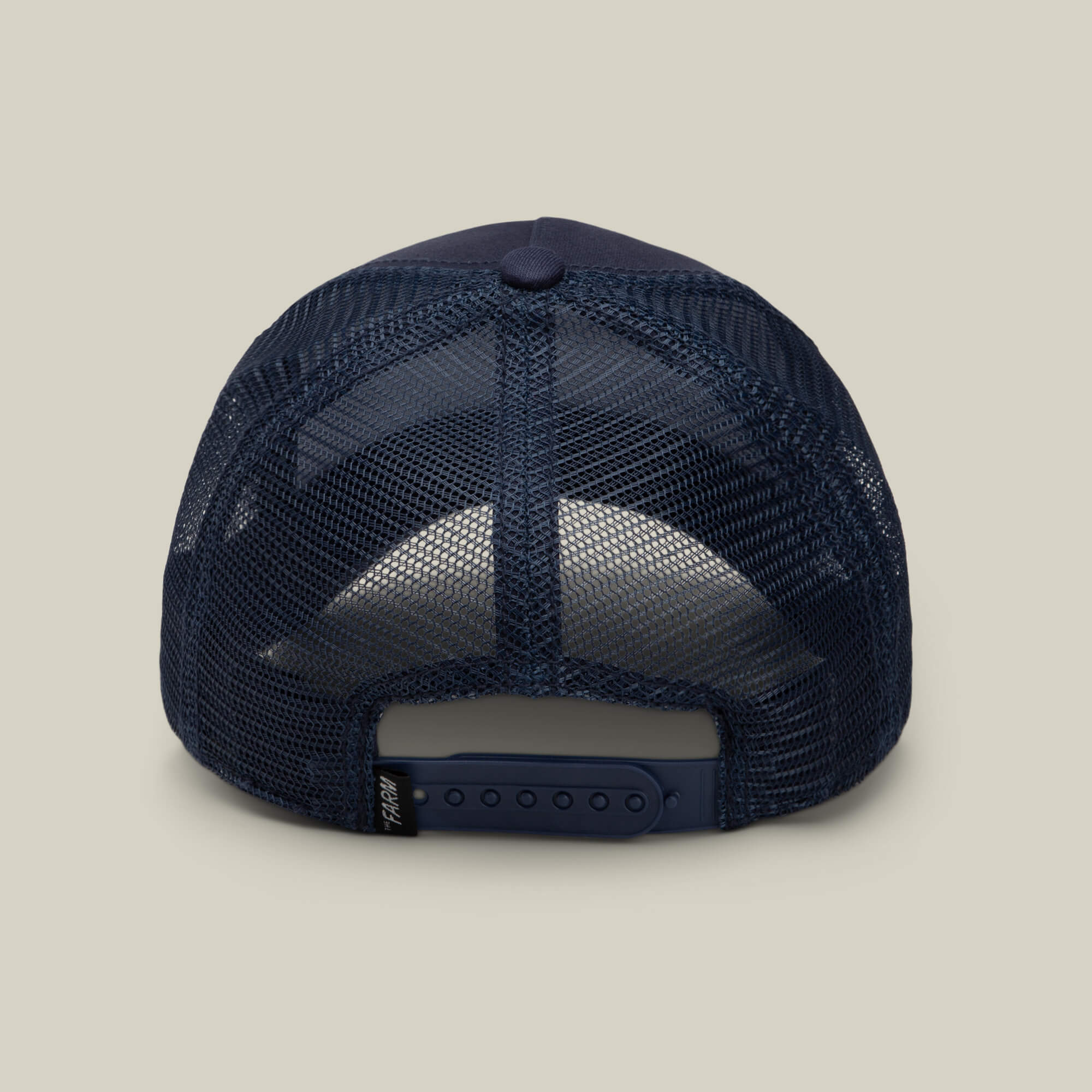 A rear view of the Goorin Bros. 1845 Goat trucker cap in navy blue mesh, featuring an adjustable snap closure and a small black tag on the strap.