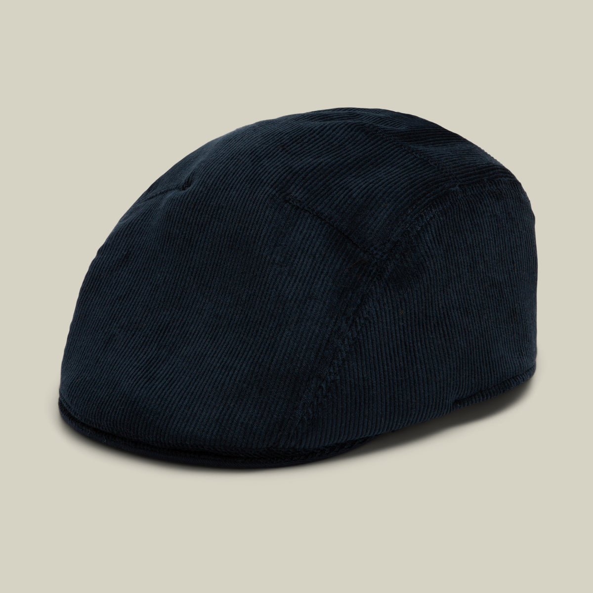 A Goorin Bros. Cozy Low Profile flatcap in the color EDGE is displayed against a plain beige background, offering a classic look that makes it perfect for everyday wear.
