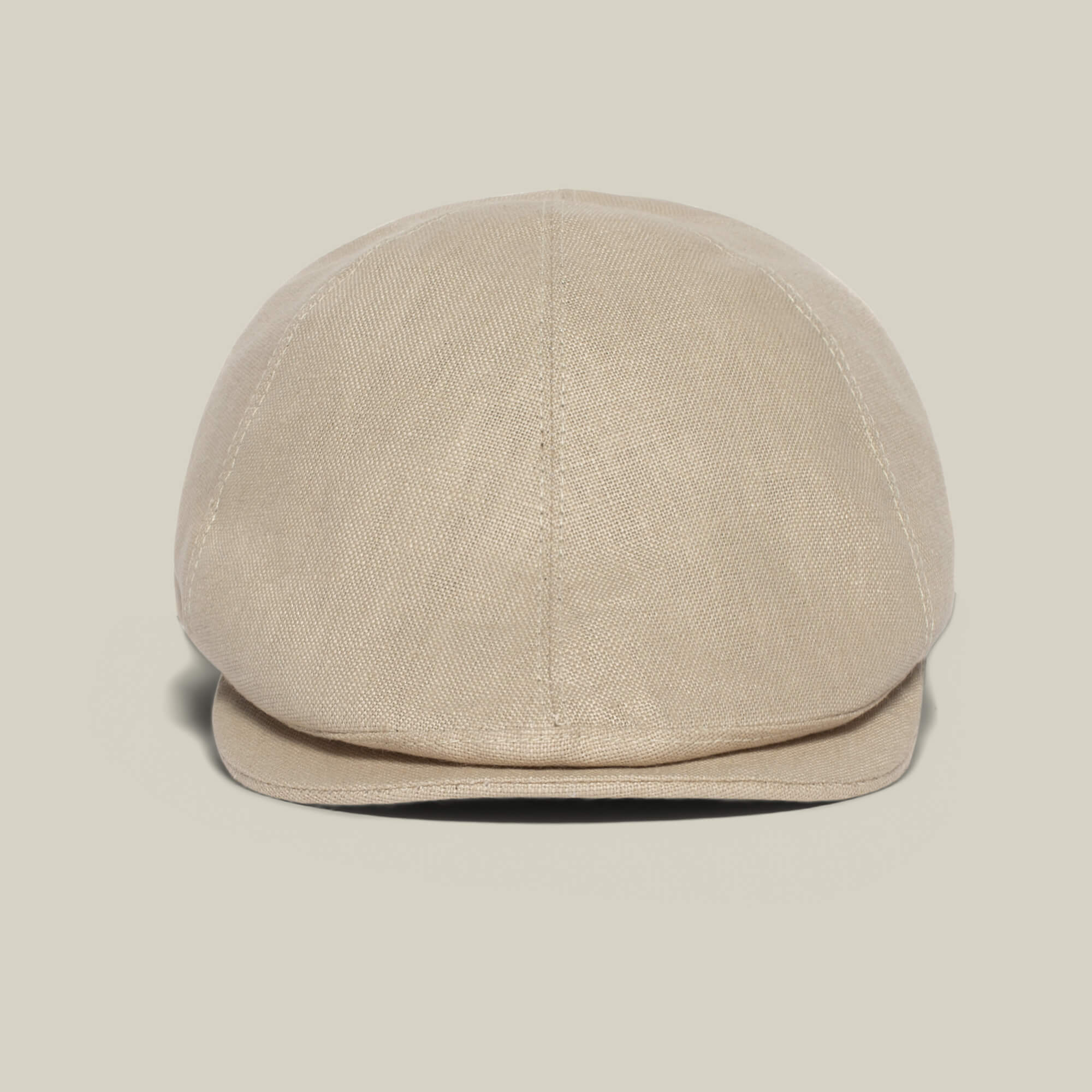 The Benjamin Paul flat cap by Goorin Bros., made of textured beige fabric, is shown front-facing against a light background—a versatile three-season hat ideal for everyday wear.
