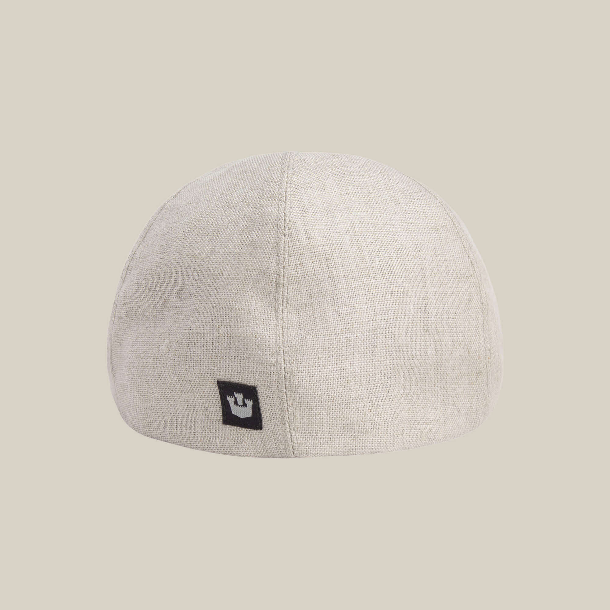The Benjamin Paul linen hat by Goorin Bros. features a light beige shade and a small black rectangular logo tag on the back—ideal for everyday wear, shown against a plain beige background.