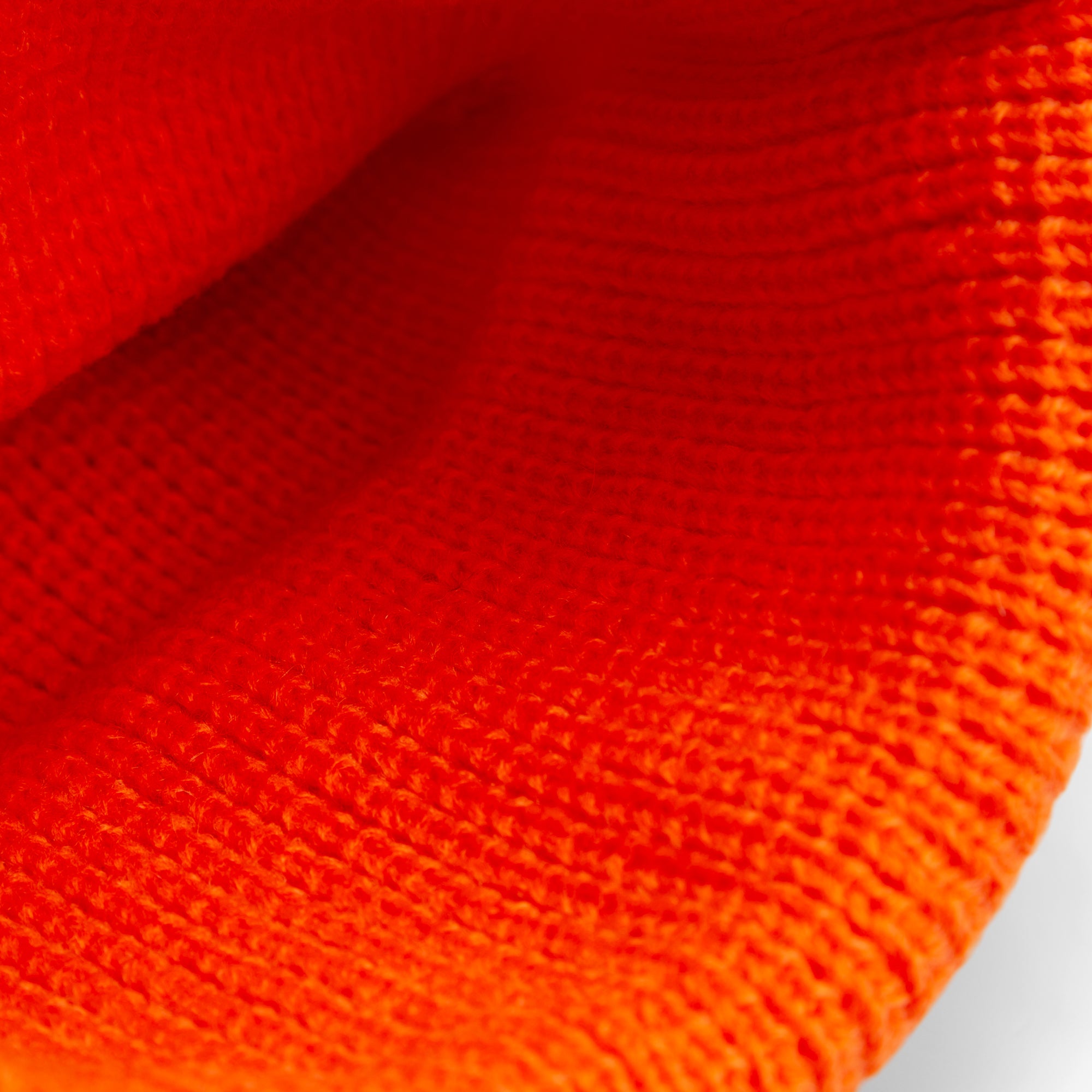 Close-up of Alpha Beta by Goorin Bros., featuring orange knitted fabric with a textured, patterned surface. All Sales Are Final.
