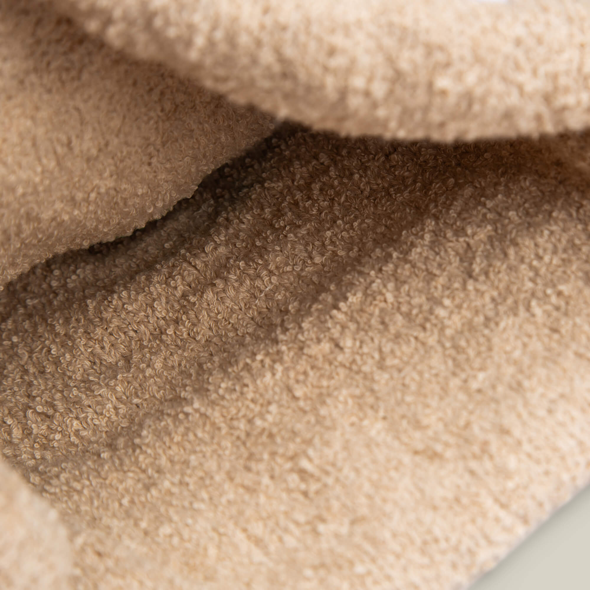 Close-up of Good Fortune by Goorin Bros.—beige, textured, soft fleece fabric with visible fibers and folds, offering cozy warmth reminiscent of a classic knit.