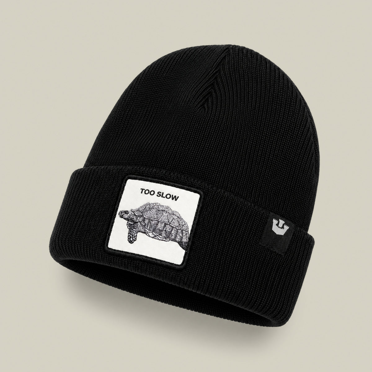 The Goorin Bros. Darn Low is a black knit beanie cap featuring a sewn patch with a turtle illustration and the text “TOO SLOW”—a true badge of honor for anyone who moves at their own pace. An additional black tag with the white Goorin Bros. logo adds a final touch, making this accessory as coveted as any elusive drop.