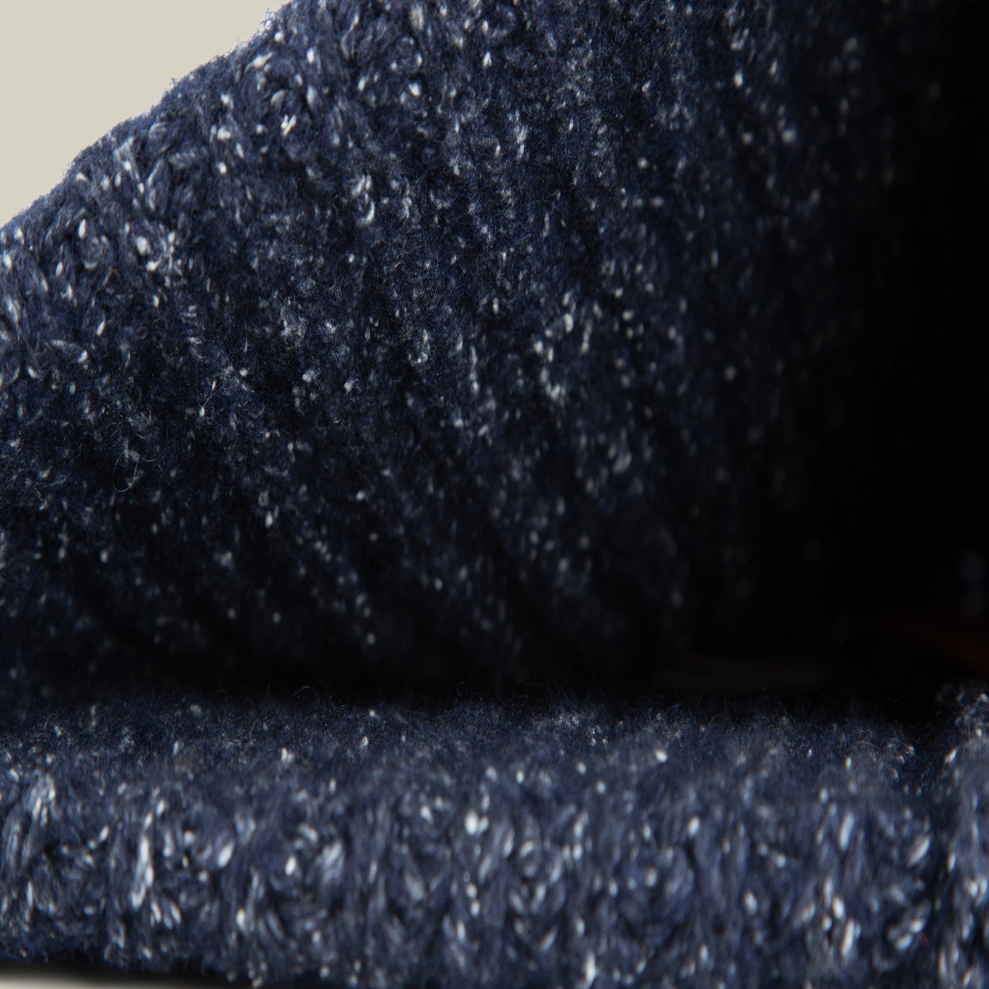 Close-up of Northstar by Goorin Bros.—a textured, dark blue merino wool knit with a ribbed pattern and detailed stitches, perfect for a luxurious beanie.