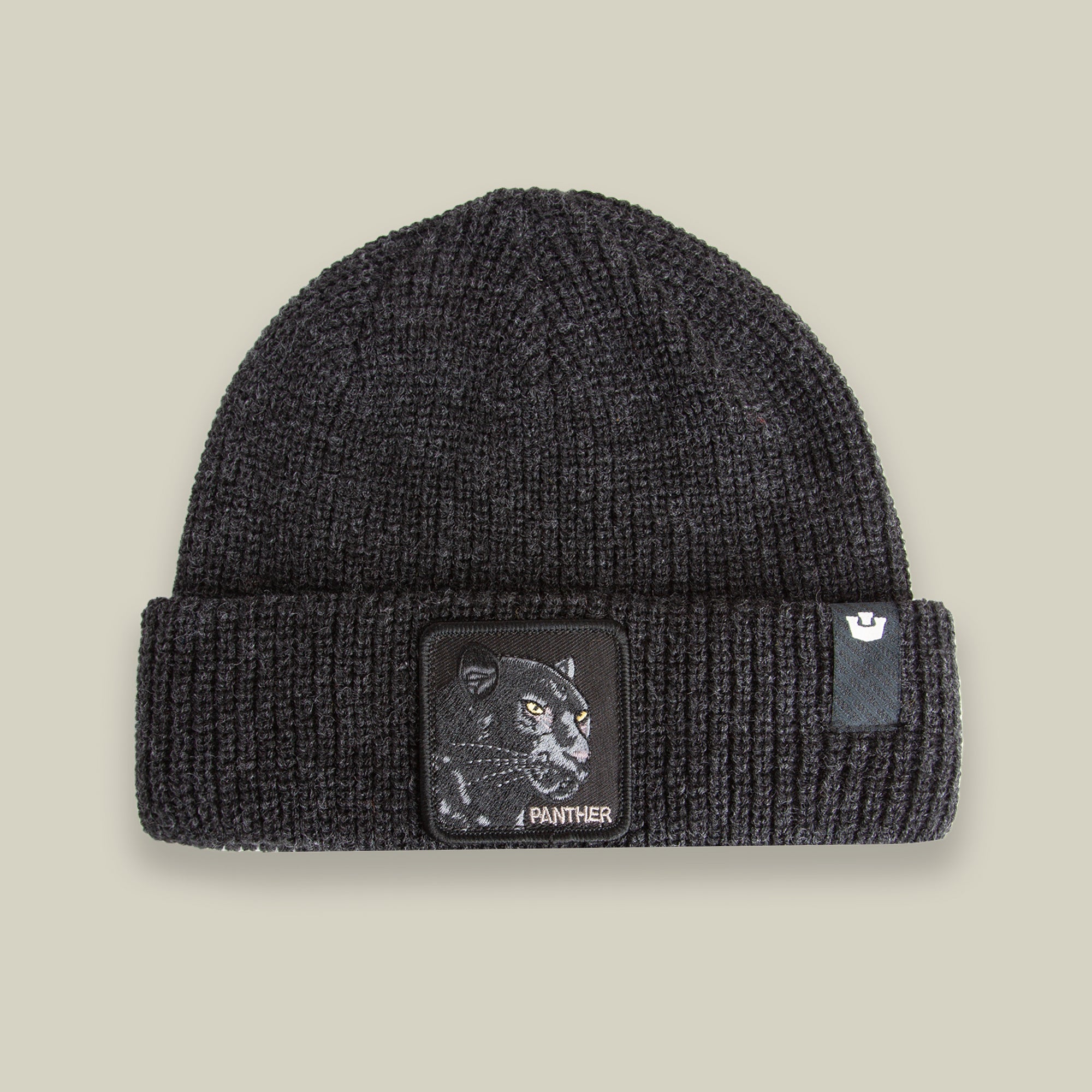 The Black Panther Beanie by Goorin Bros. in VOID features a warm knit design with a folded brim, a bold panther patch, and the word "PANTHER" on the front.
