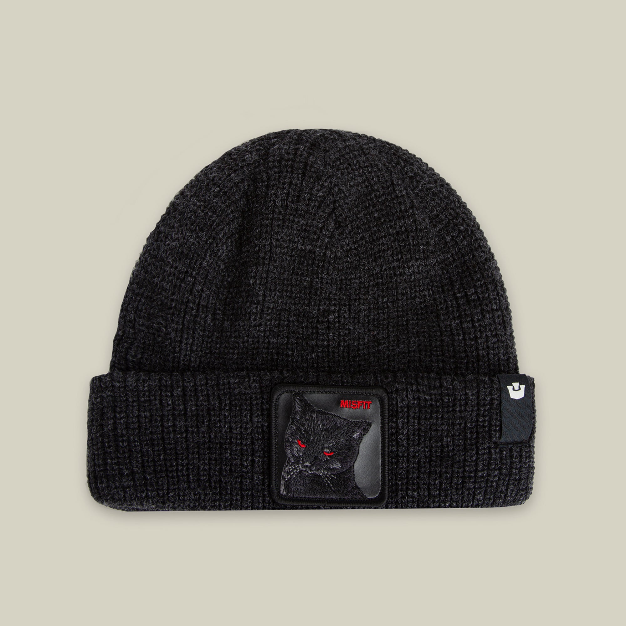 The Misfit Beanie by Goorin Bros. in VOID features a black knit design with a cat patch showing an embroidered black cat with red eyes and a small logo tag on the cuff.