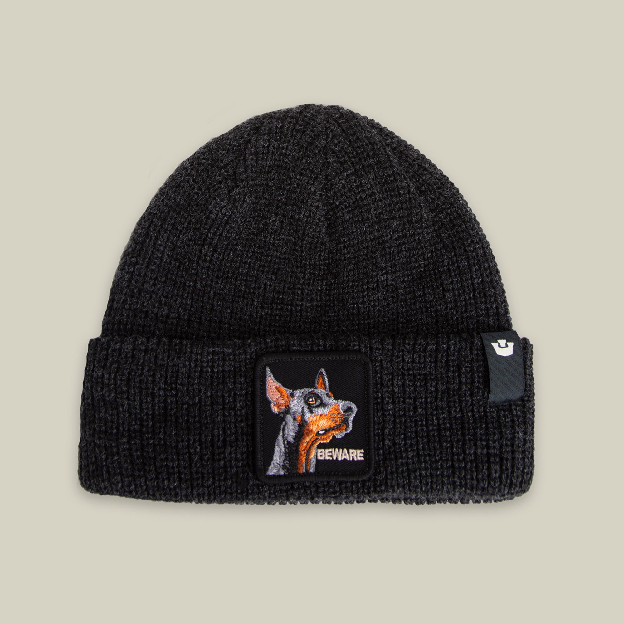 The Beware Dog Beanie by Goorin Bros. in VOID is a heavyweight knit beanie with a front cuff patch showing a dog's face and "BEWARE"—perfect for bold style and warmth.