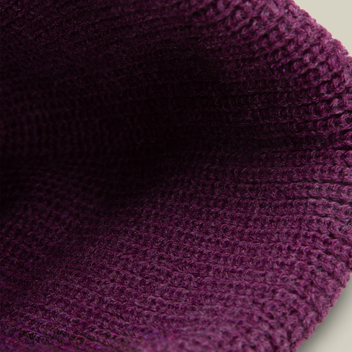 The Boss Beanie by Goorin Bros. is a burgundy knit beanie shown in close-up detail, highlighting its textured wool knit construction and ribbed pattern against a neutral background.