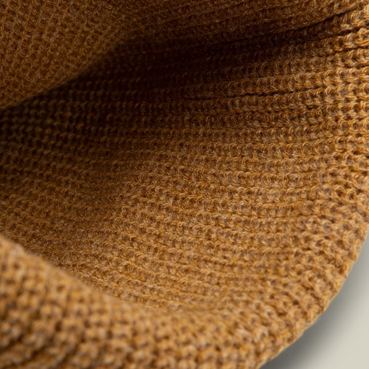 The Boss G Beanie by Goorin Bros is a tan and brown knit beanie with a textured, ribbed knit pattern shown in close-up detail against a neutral background.