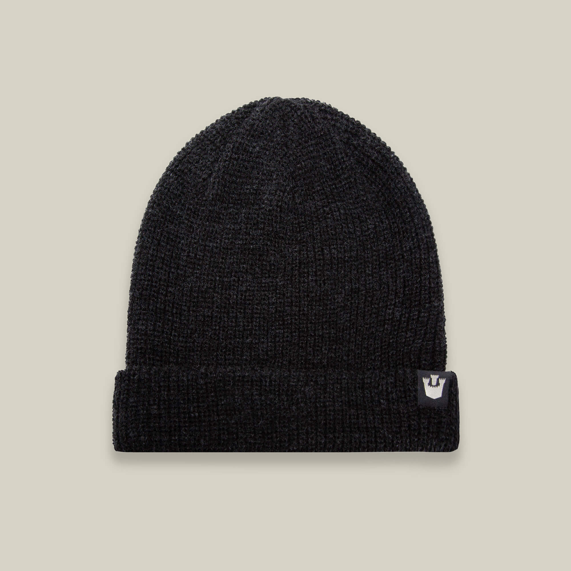 The Goorin Bros. Air to Fakie beanie in black features a folded brim, lightweight poly knit for all-season wear, and a small white logo tag on the right side, shown against a plain beige background.