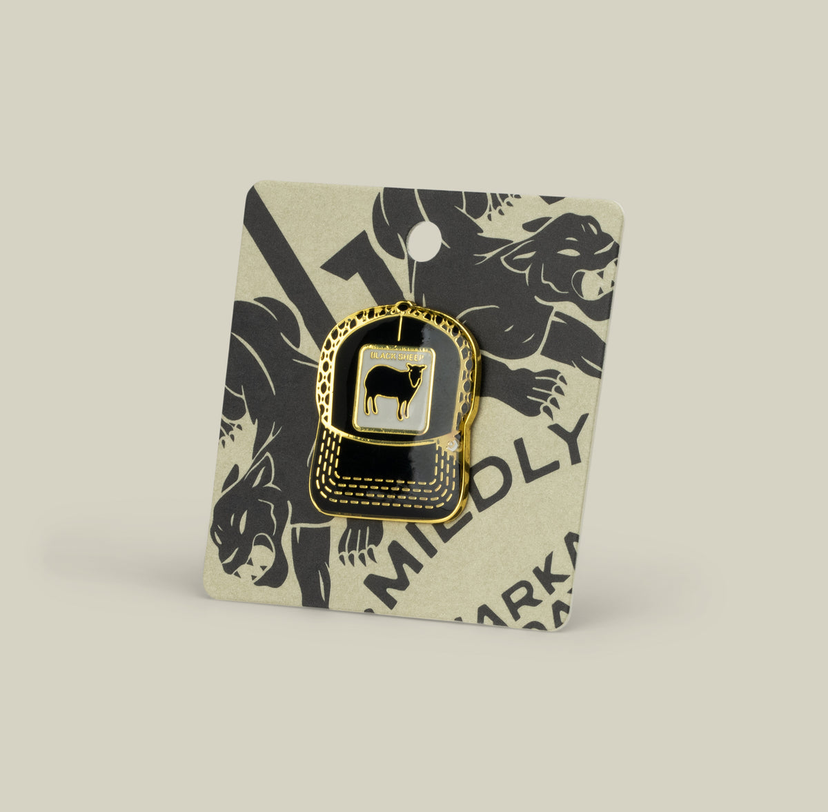 The Black Sheep Trucker Pin by Goorin Bros. is a gold and black enamel zinc alloy pin on a card with bold text and animal illustrations in the background.