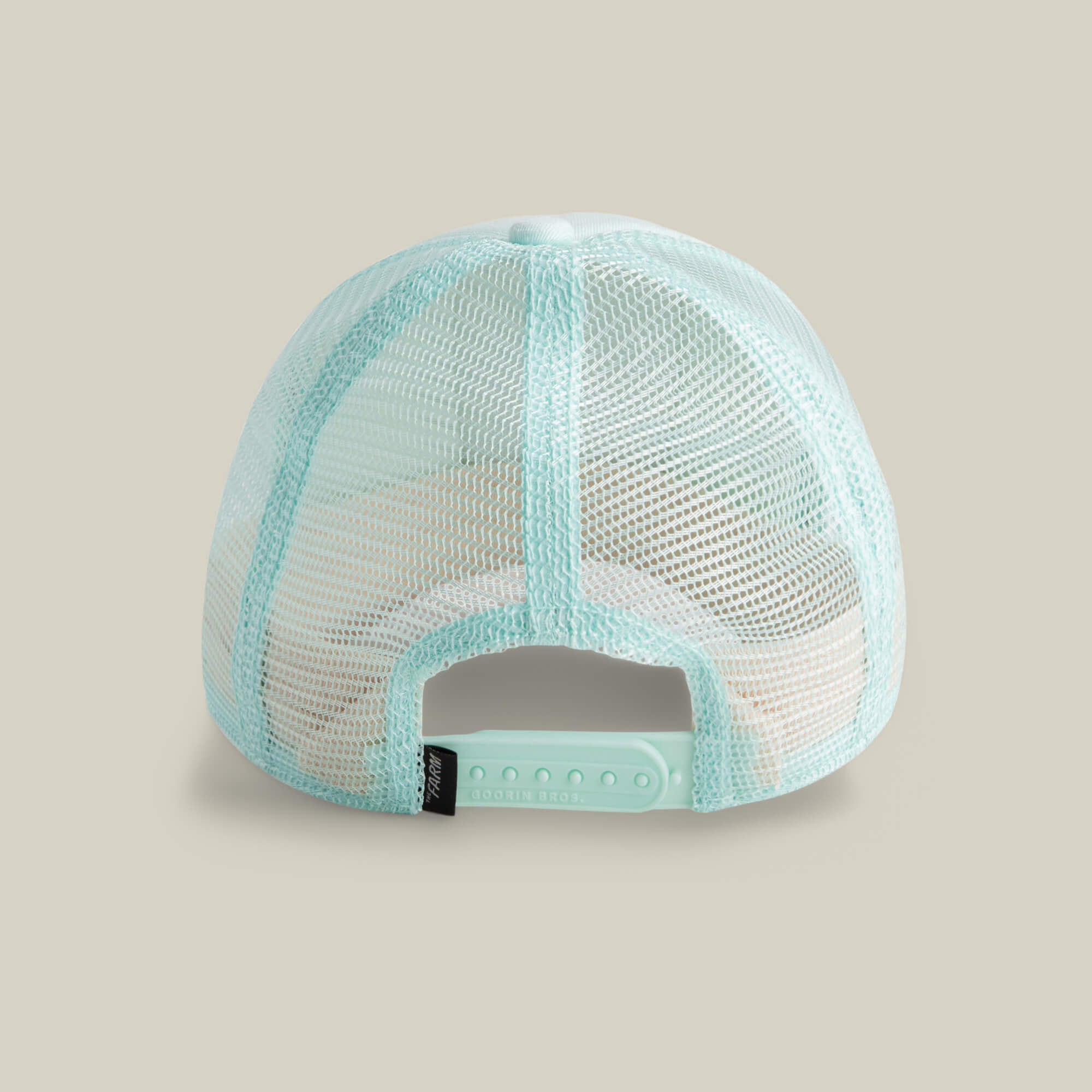 The Goorin Bros. Lil Squad hat is a light blue mesh trucker cap, shown from the back with an adjustable snap closure, small black side tag, and playful embroidered flamingo—perfect for squad goals.
