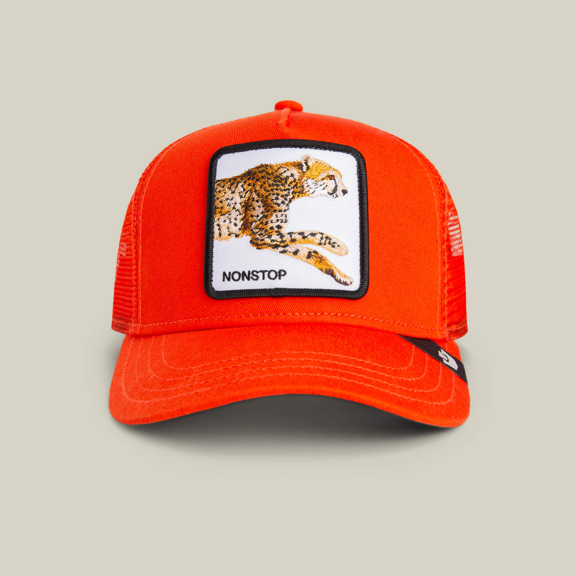 Front view of The Nonstop Cheetah Mini kids cap by Goorin Bros., featuring an orange crown, mesh trucker style, and a patch with a cheetah and "NONSTOP" embroidered below.