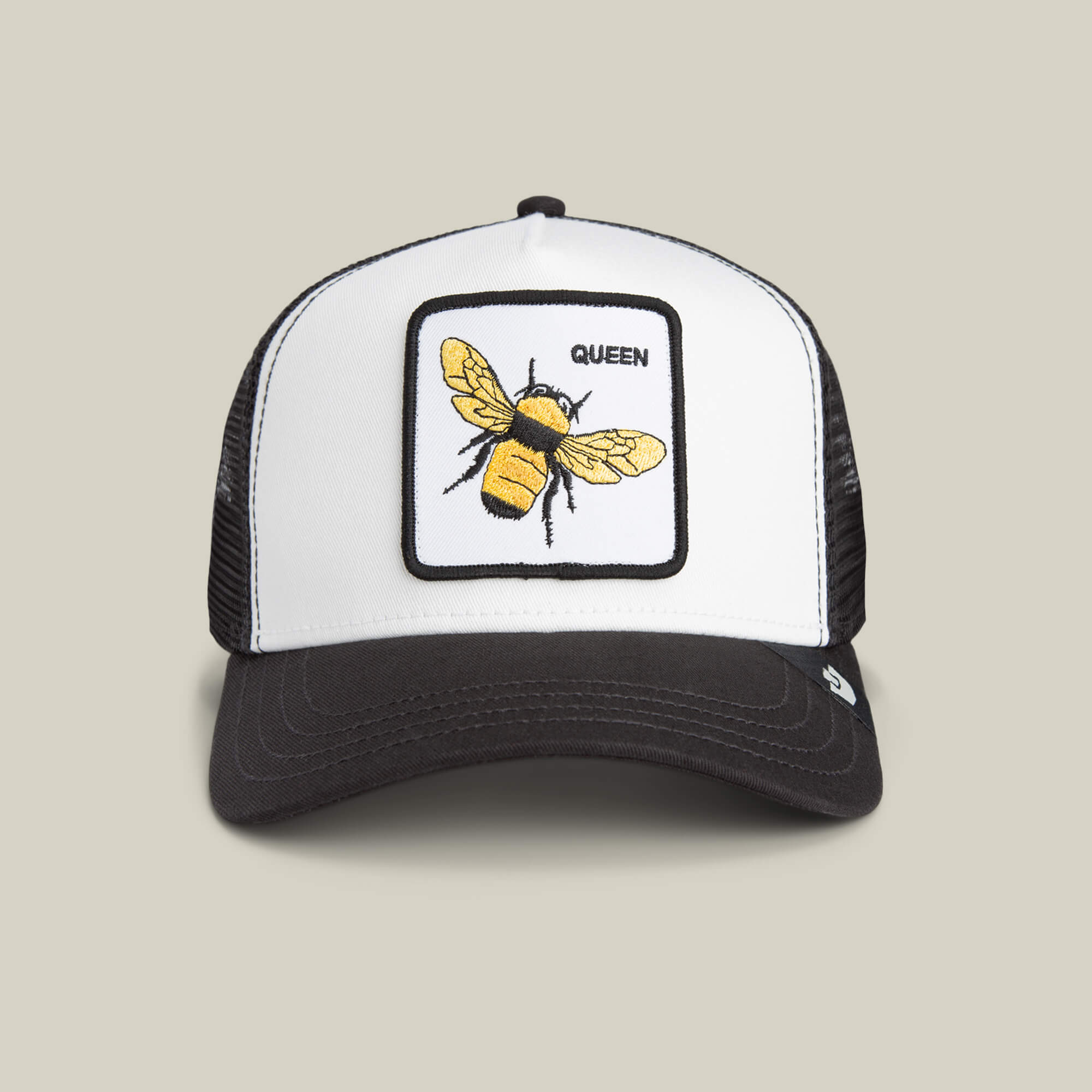 The Queen Bee Mini by Goorin Bros. is a black and white kids trucker cap with a front panel patch of a golden bee crowned with the label QUEEN.