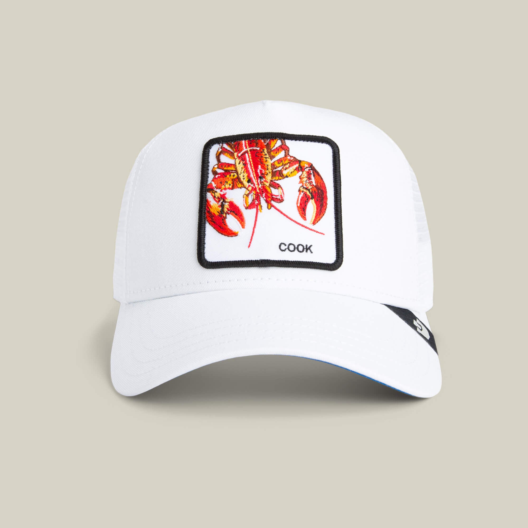 The Lemme Cook Mini by Goorin Bros. is a white kid-sized hat with a colorful lobster patch and "COOK" text, shown on a plain beige background under a soft mini spotlight.