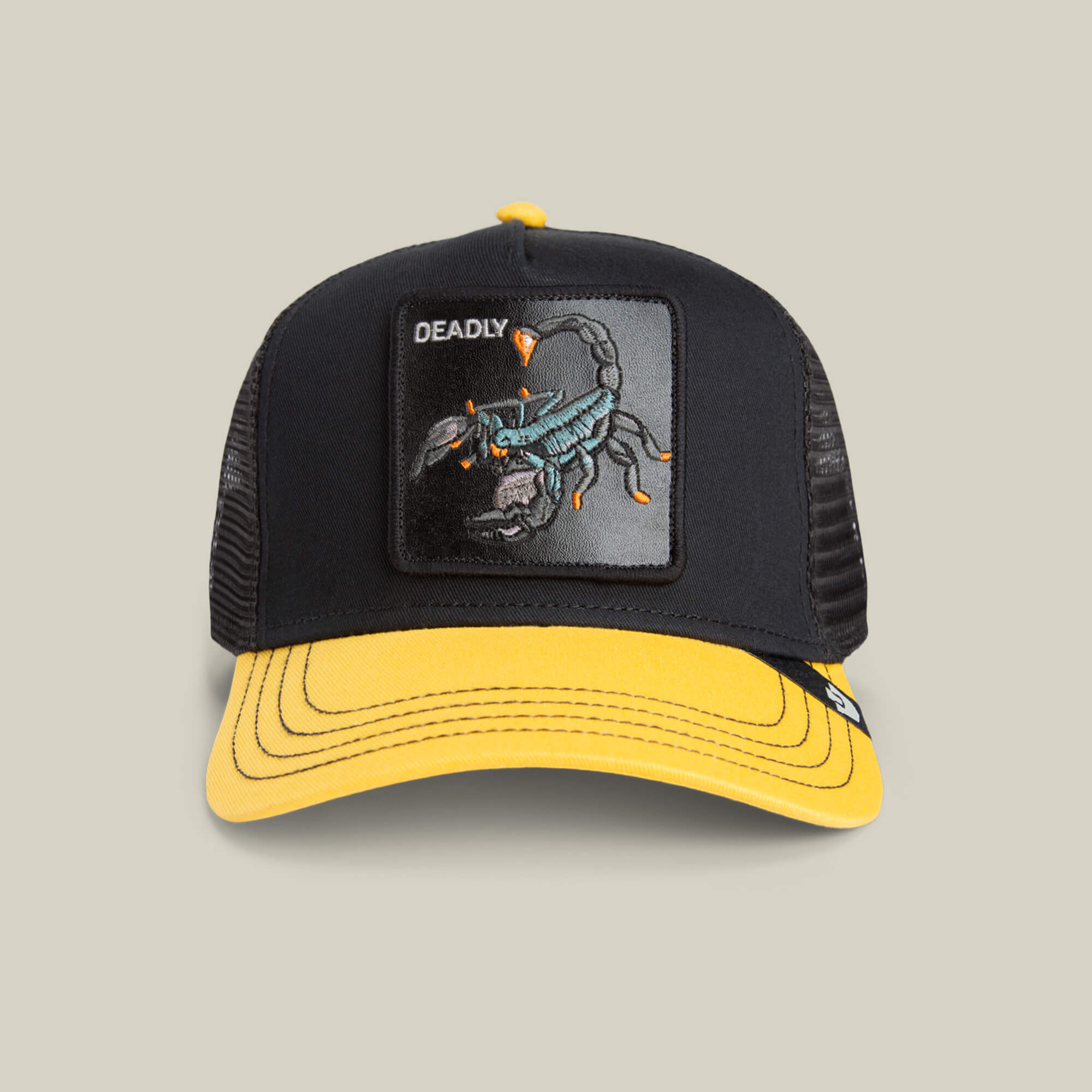 The Deadly Mini kids trucker hat by Goorin Bros. features a bold scorpion patch with DEADLY embroidered above it, and comes in black and yellow with a yellow brim.