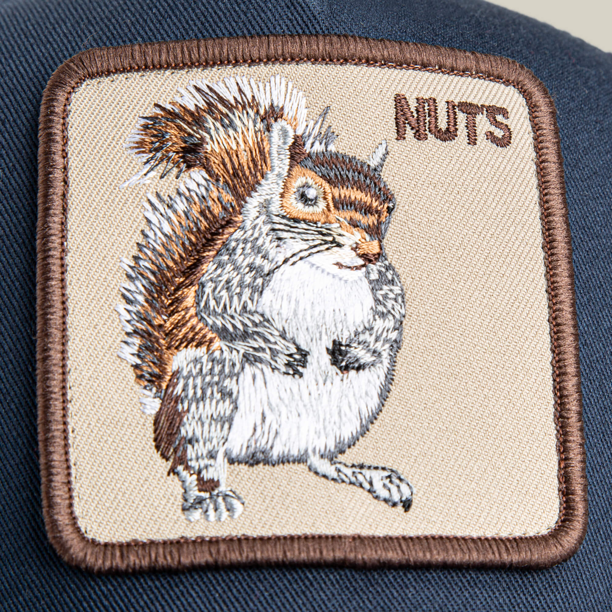 The Goorin Bros. Nuts Mini patch features an embroidered squirrel and "NUTS" on navy blue—perfect for your kid-sized cap or small hat.