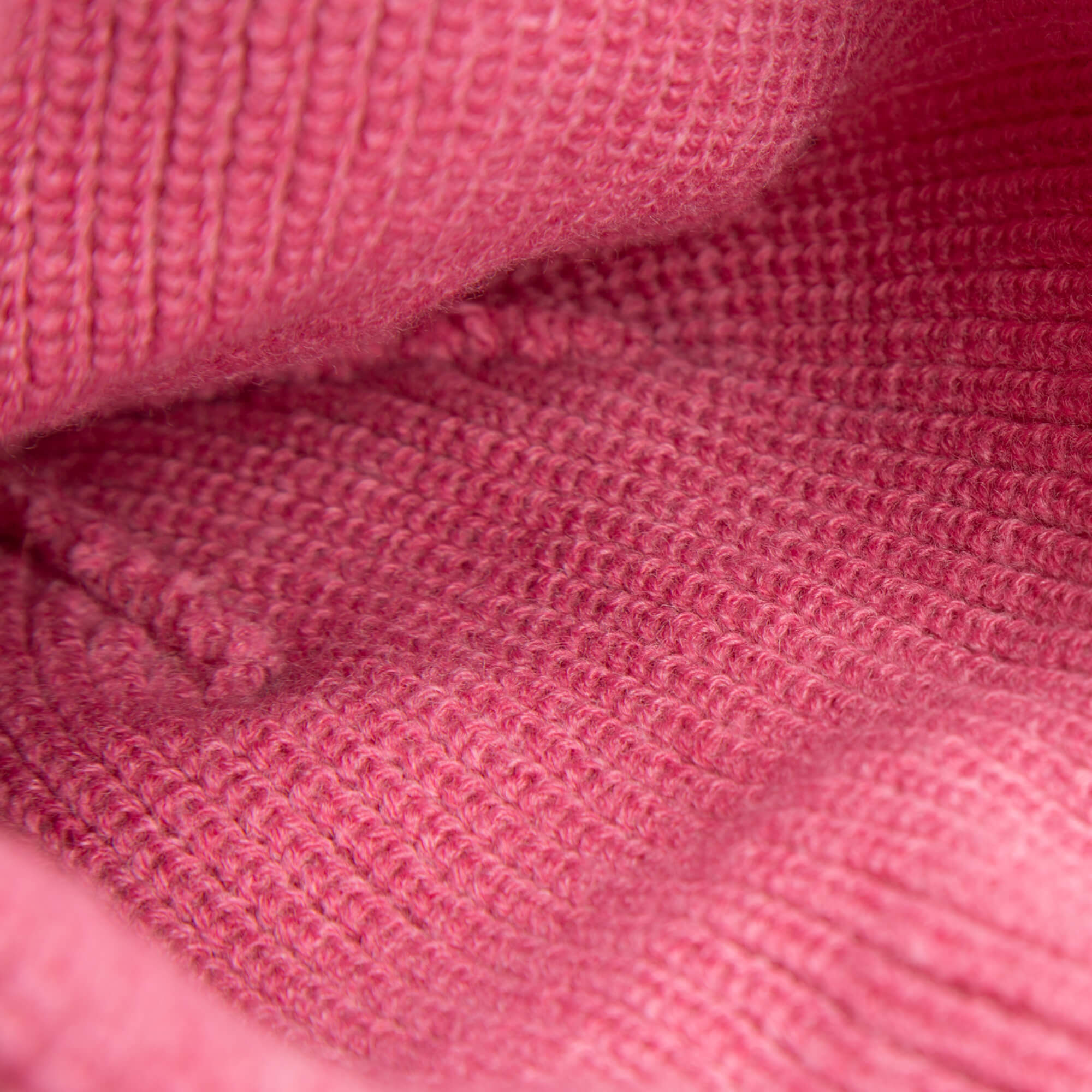 Close-up of the soft pink knit texture and stitching details on Goorin Bros.'s The Cuddly Beanie Mini, perfect for kids and featuring a cute teddy patch.