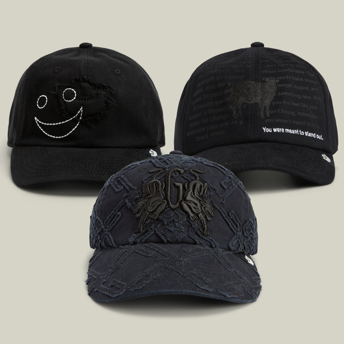 Three black baseball caps from Goorin Bros.’ The Dad Who Stepped Up Bundle are displayed against a light background, featuring unique embroidered designs and text, including a striking longhorn silhouette and a playful smiley face on textured pattern caps.