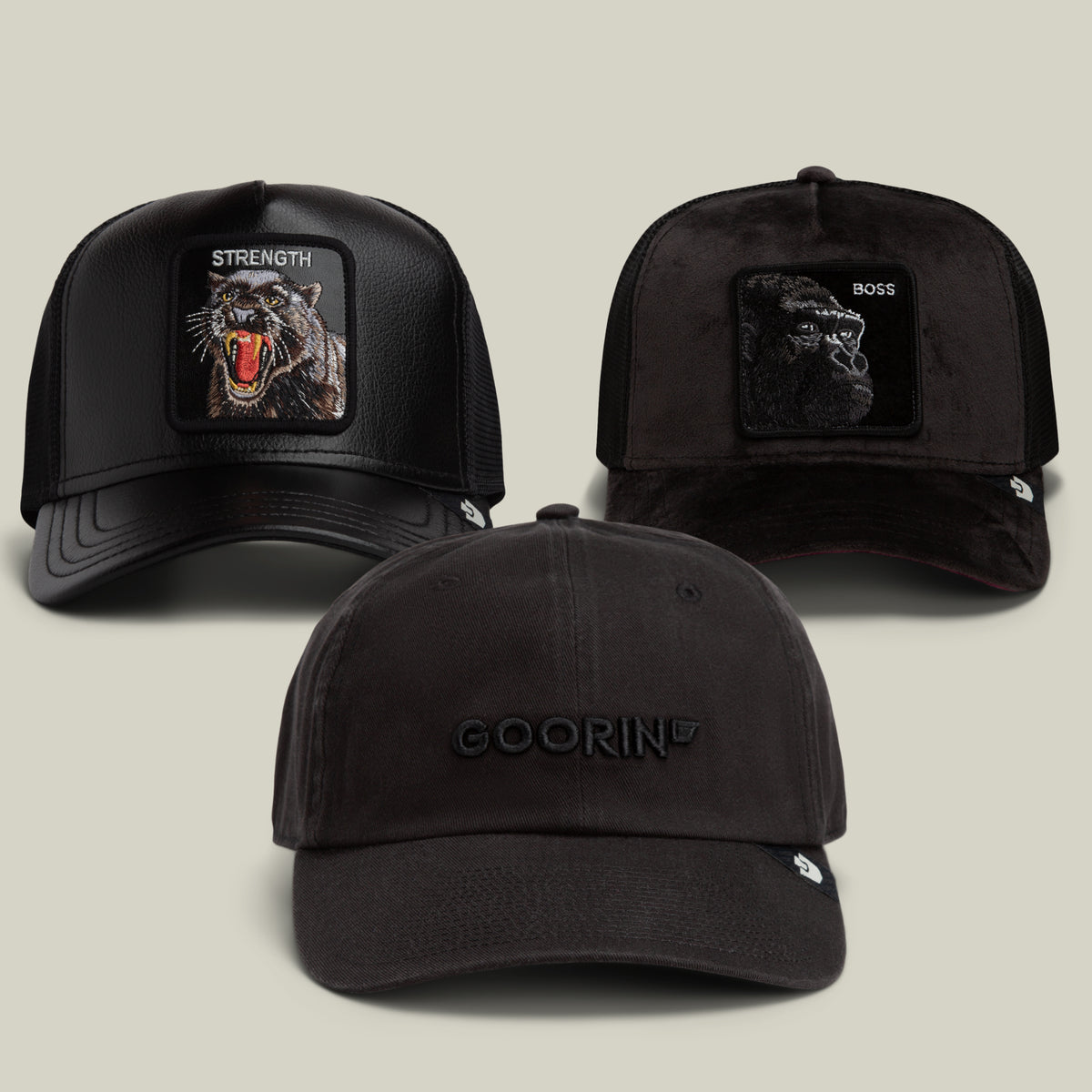 The Dark Side Bundle by Goorin Bros. features three black hats: two trucker caps with animal patches—one bold “STRENGTH” wolf patch and another labeled “BOSS”—plus a low-key black dad cap with GOORIN embroidered on the front.