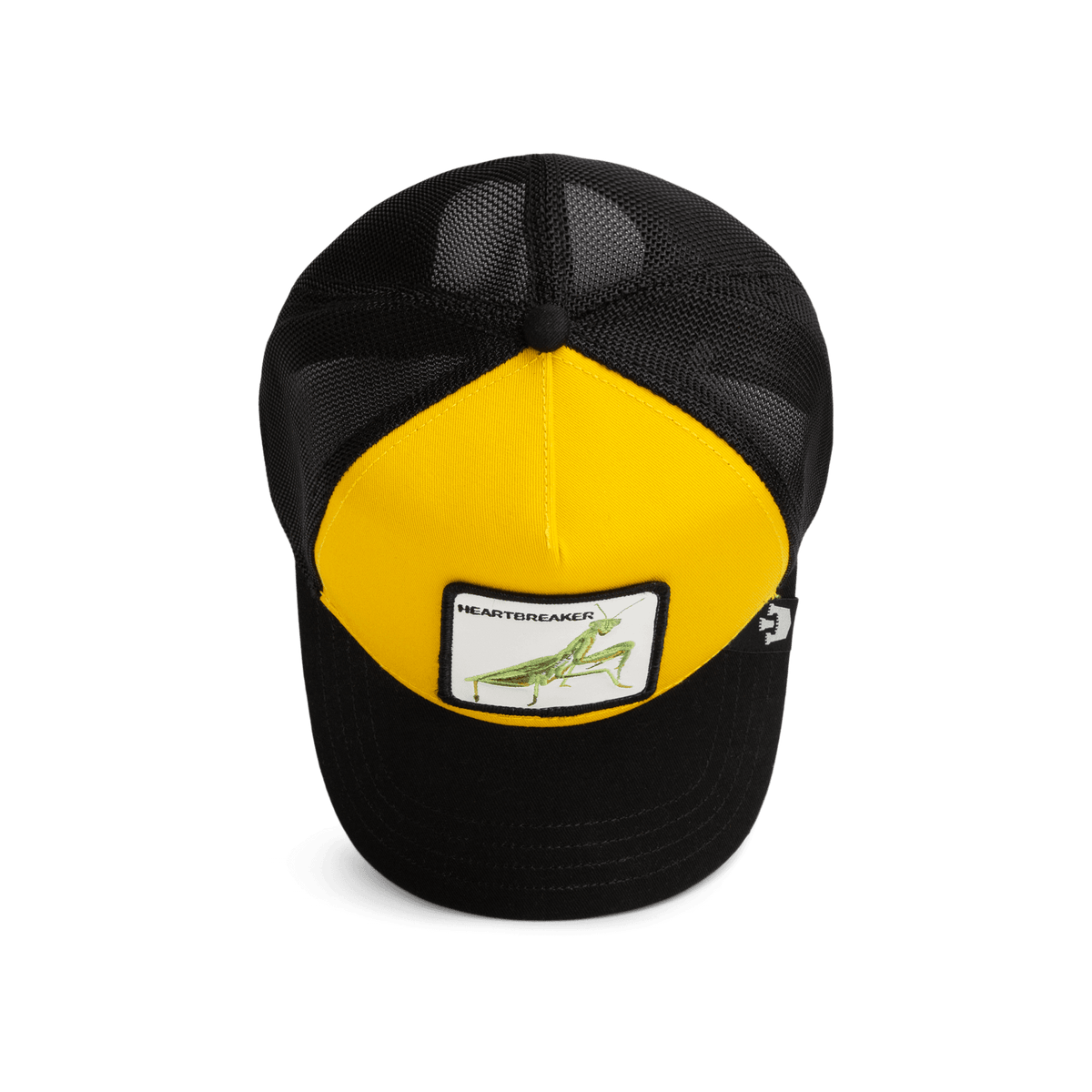 The Heartbreaker by Goorin Bros is a black and yellow trucker hat with a mesh back and snapback closure, featuring a grasshopper patch on the yellow front panel, shown on a white background.