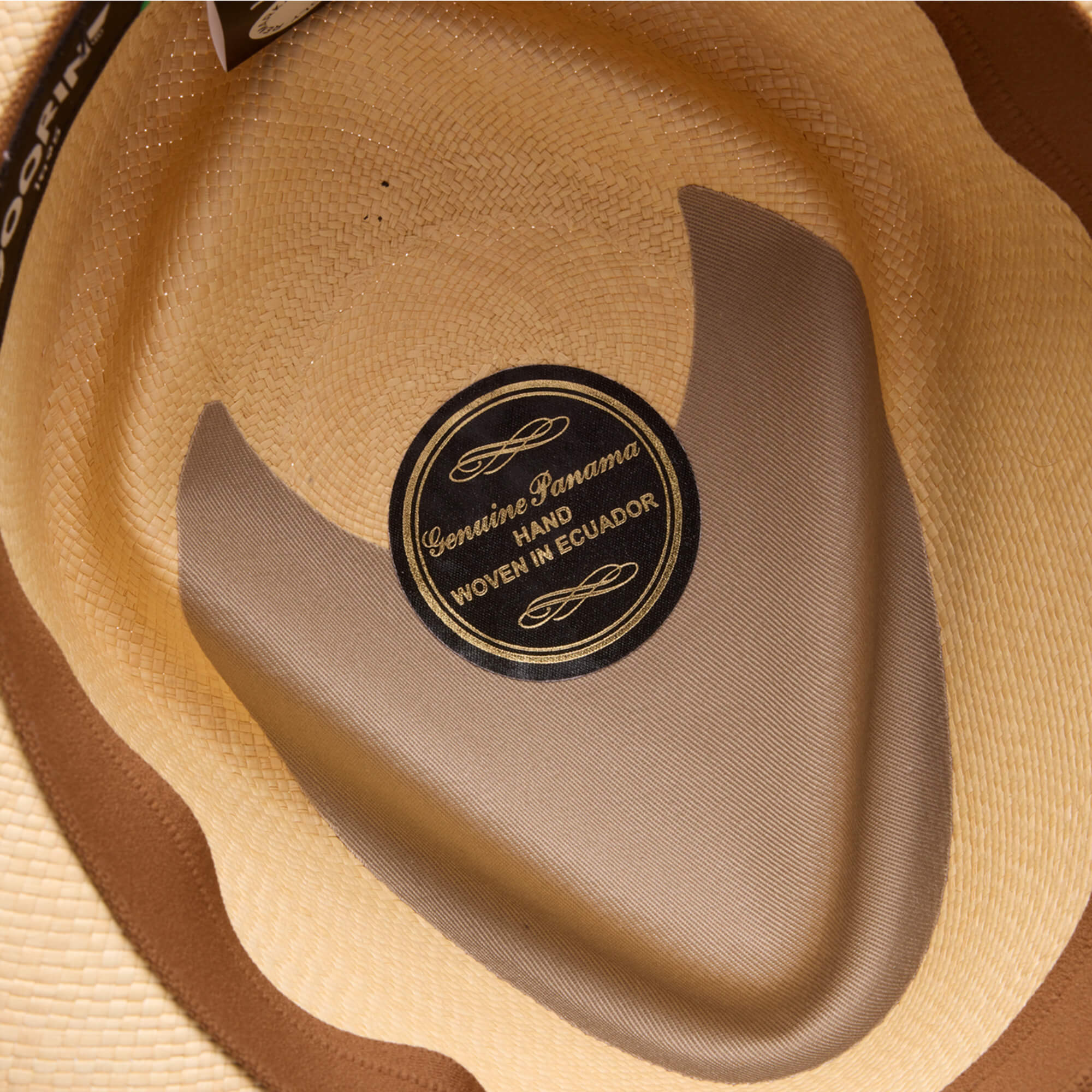 Close-up of the inside of a genuine straw hat labeled "That's All Folks" by Goorin Bros.