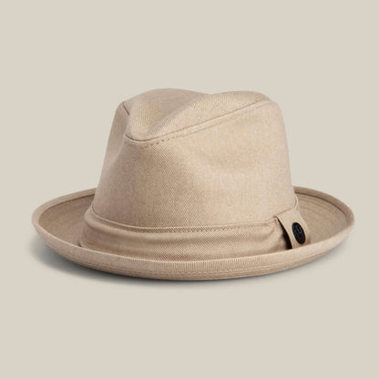 The Big Stepper by Goorin Bros. is a beige fedora with a wide brim and black button detail on the side, shown against a plain light background.
