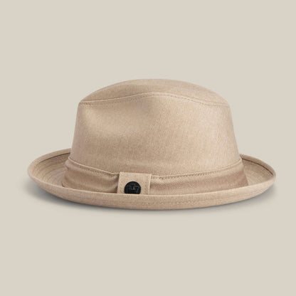 The Goorin Bros. "Big Stepper" is a beige fedora with a matching hatband and a small round black emblem on the side, displayed on a neutral background.